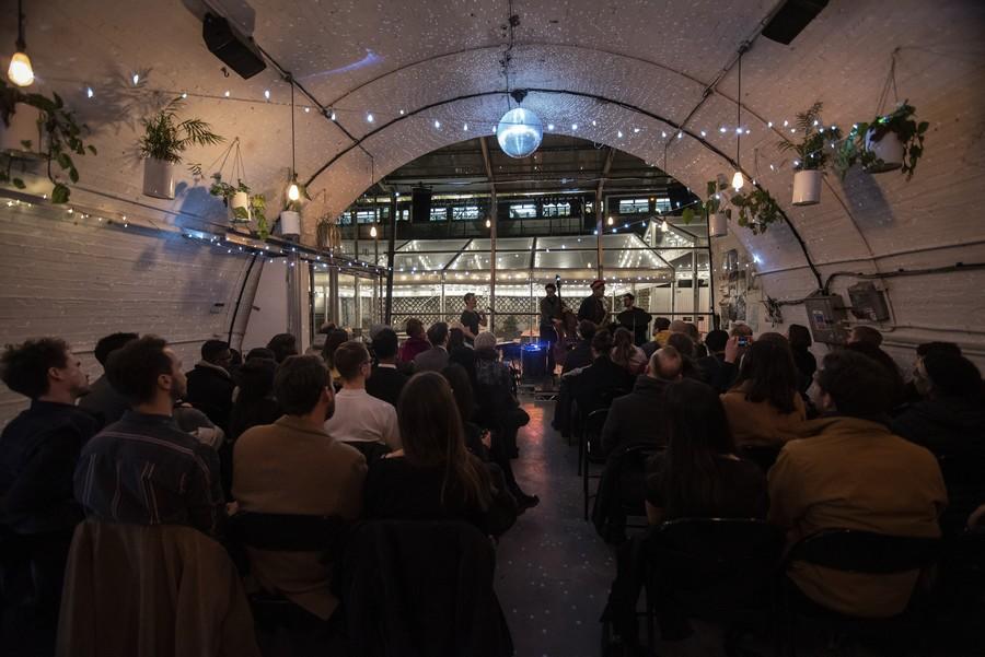 Springs Bar & Garden event space with cozy lighting for workshops and live performances.