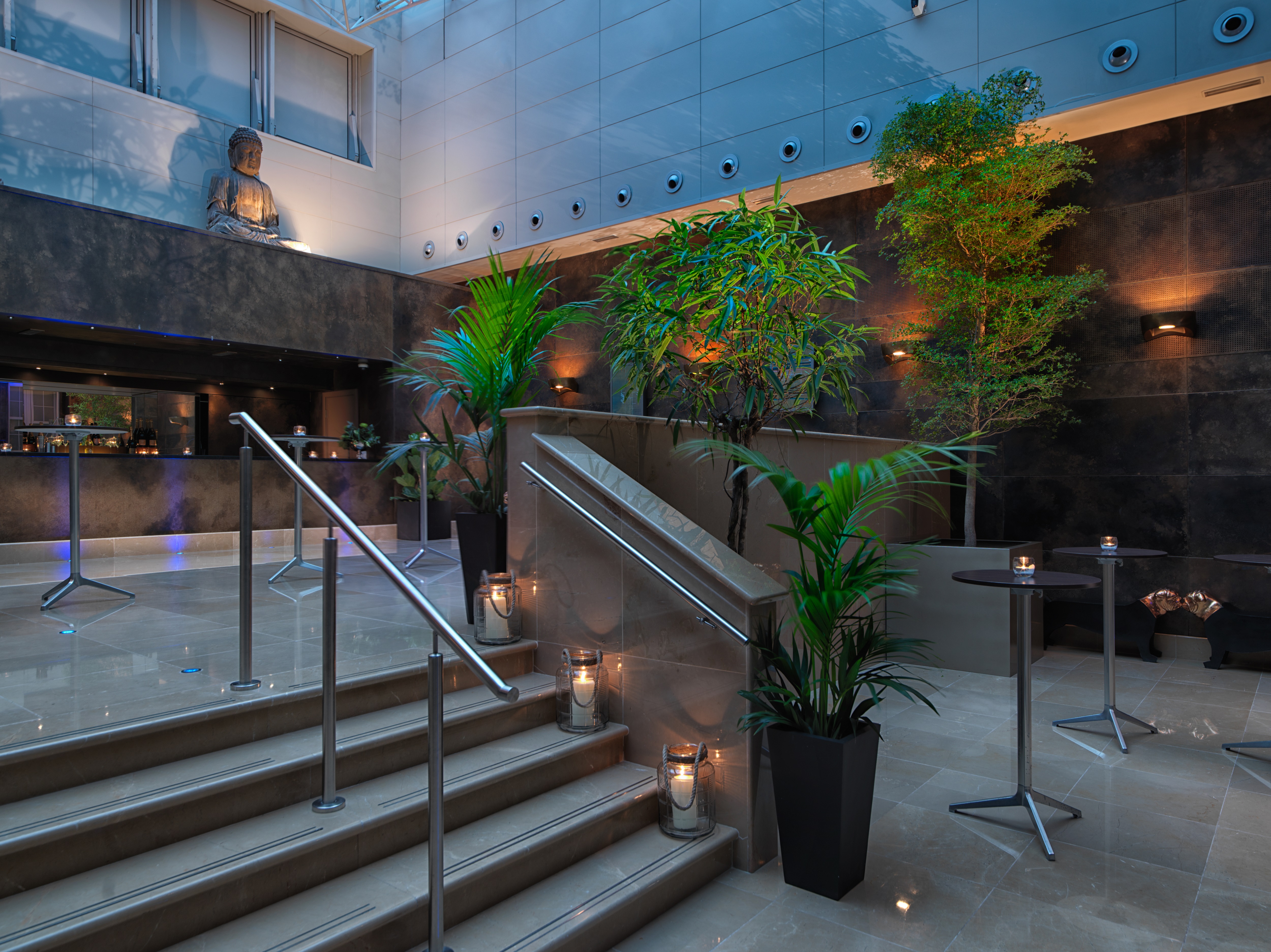 Atrium at The May Fair Hotel, modern staircase, elegant event space for gatherings.