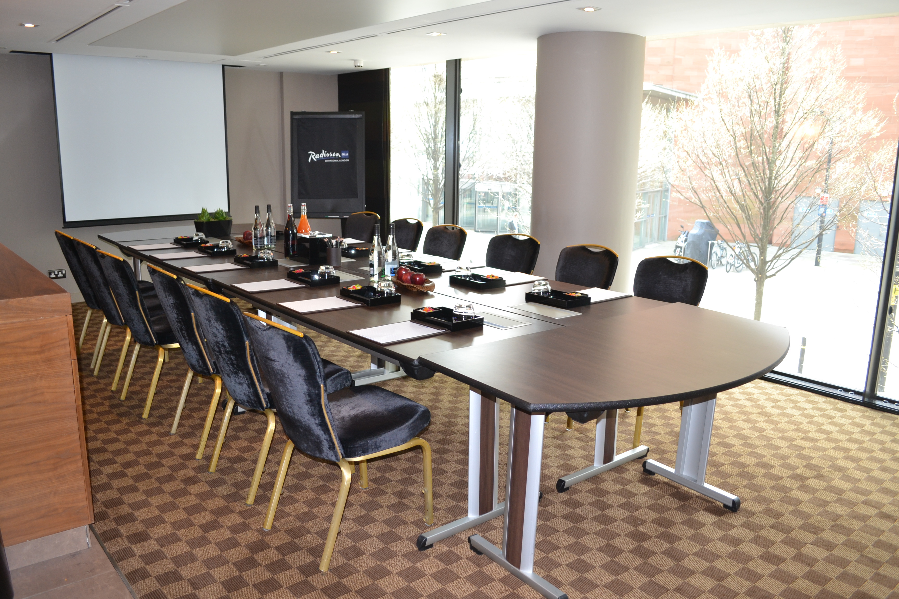 Meeting room at Peterloo Hotel, featuring a long table and natural light for events.