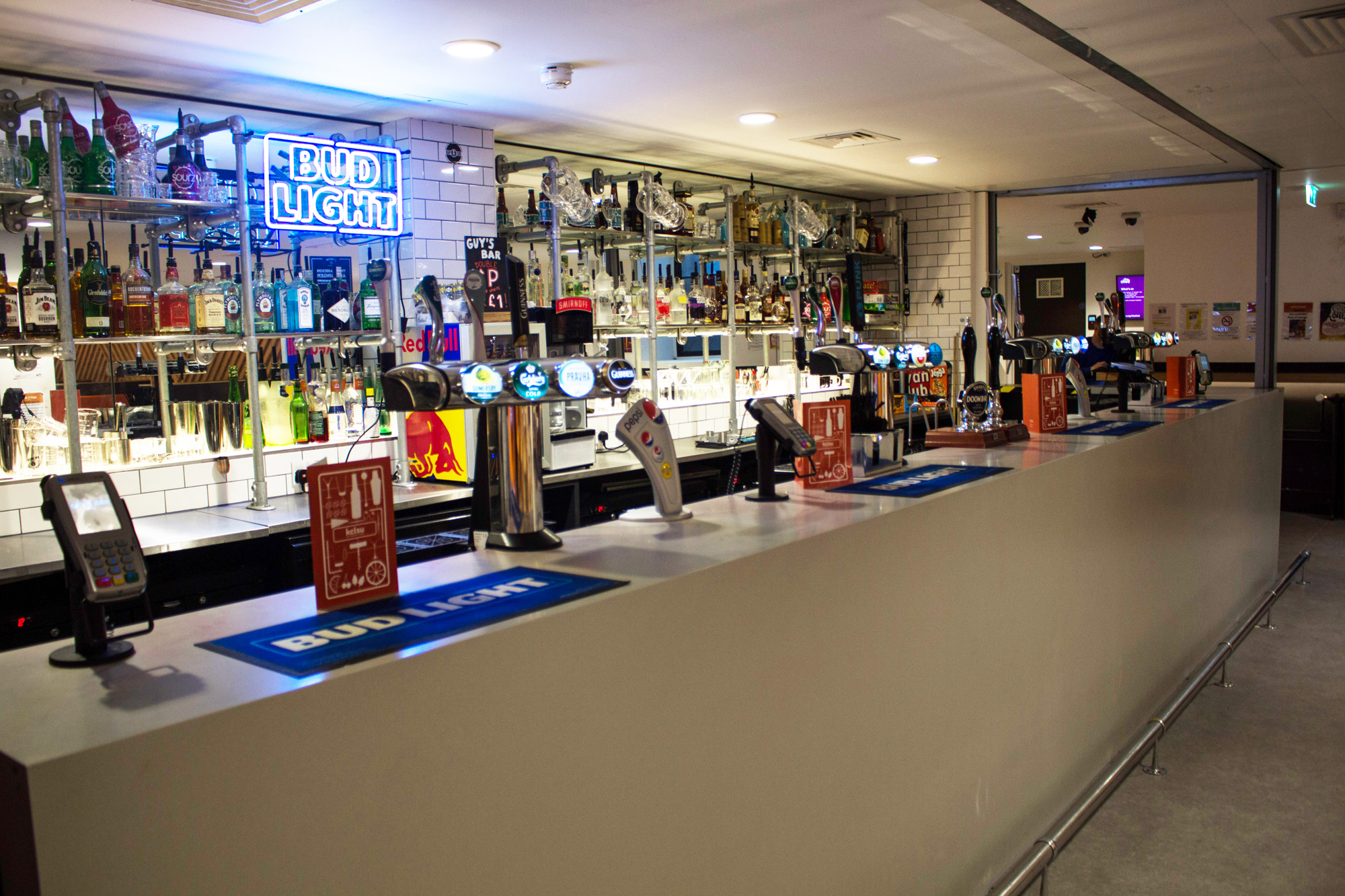 "Guy's Bar London with illuminated signage, perfect for networking events and social gatherings."