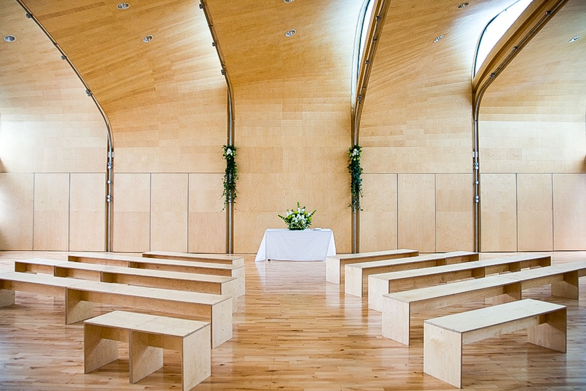 Minimalist event space at Siobhan Davies Studios with natural light and floral accents.