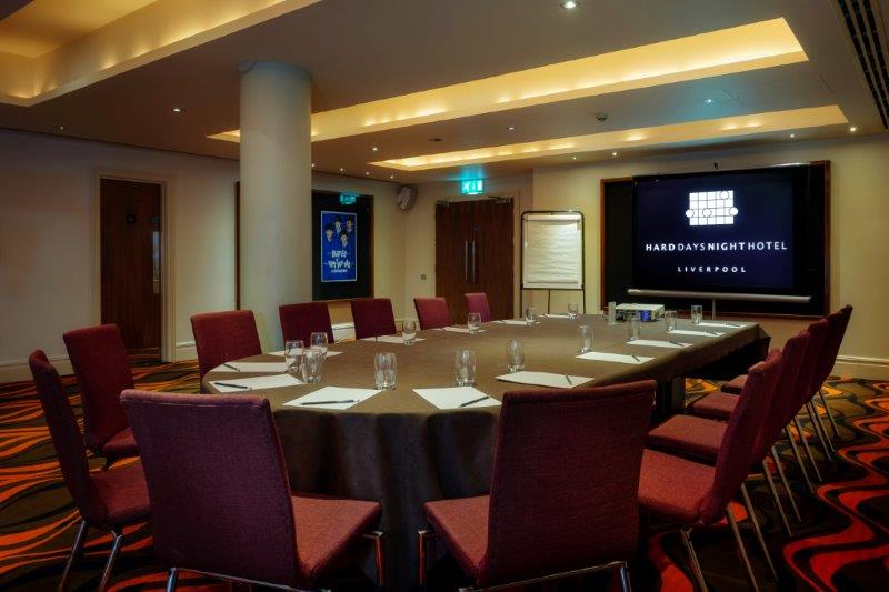 Hard Days Night Suite: spacious meeting room with round table for corporate events.