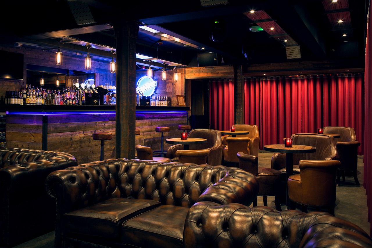 Stylish bar with leather seating, ideal for networking events and private gatherings.