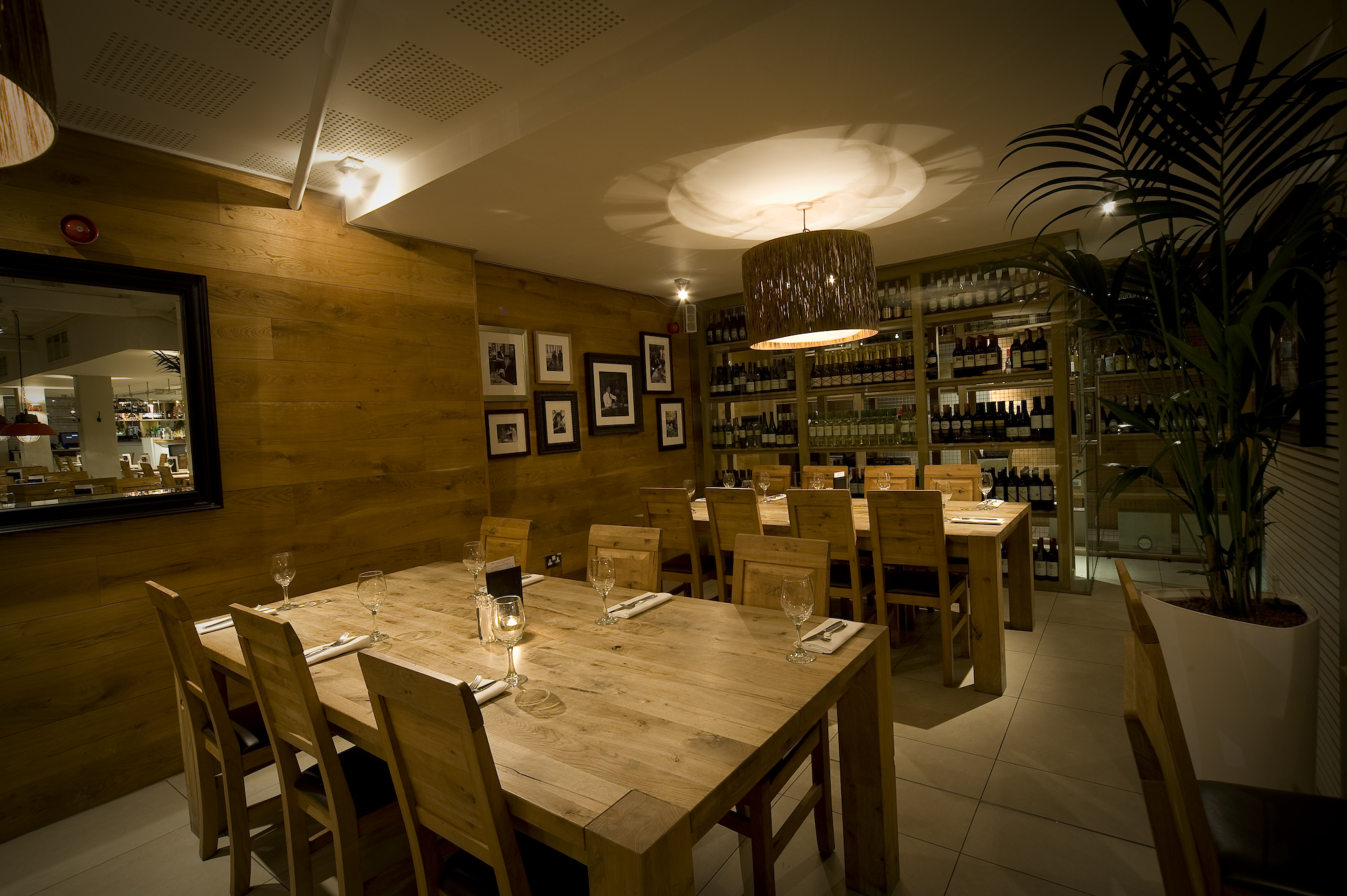 Intimate dining space with warm wood tones for networking dinners and private events. - Banner