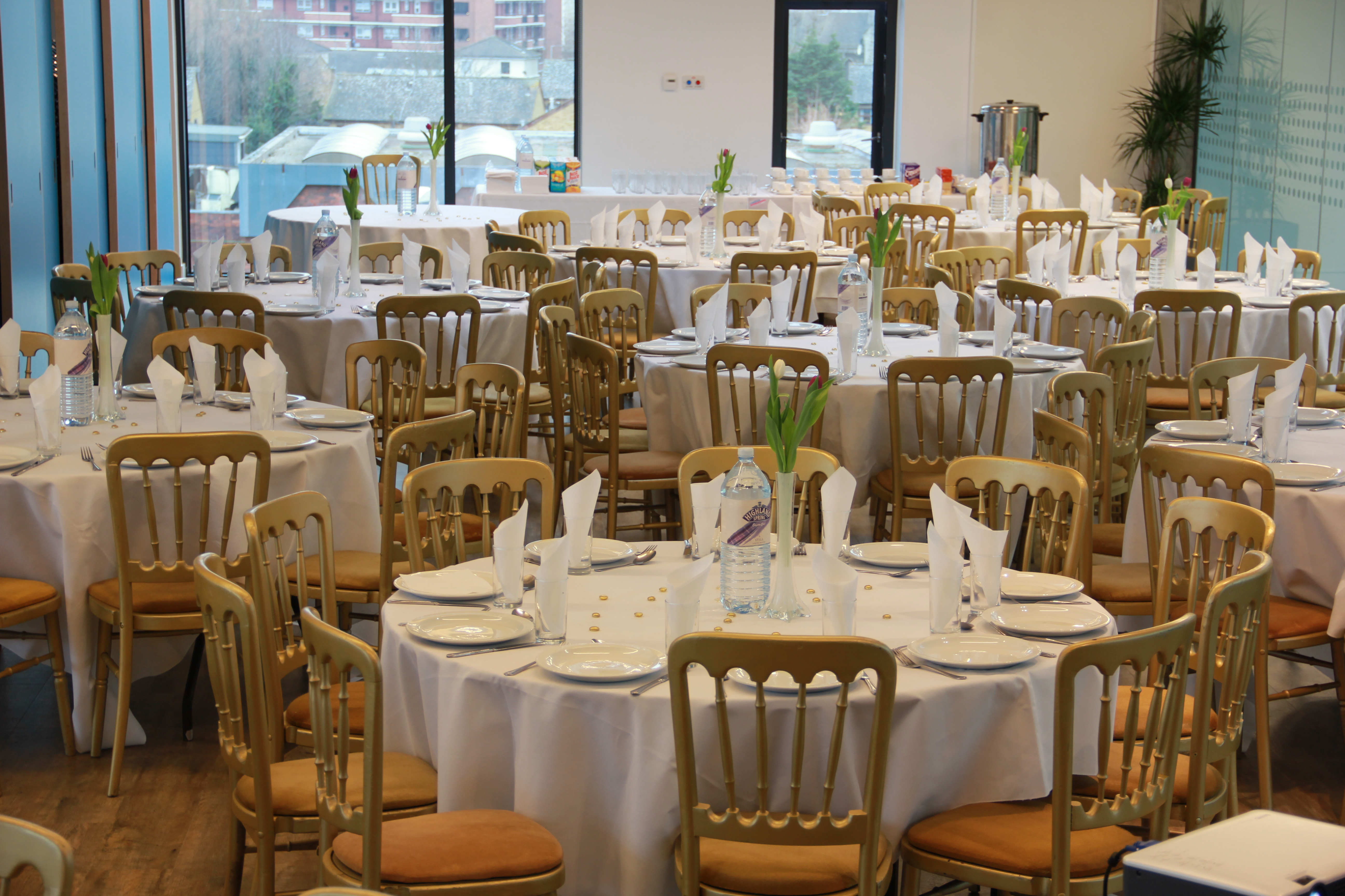 Community Hall in Osmani Trust, elegant banquet setup with round tables for corporate events.