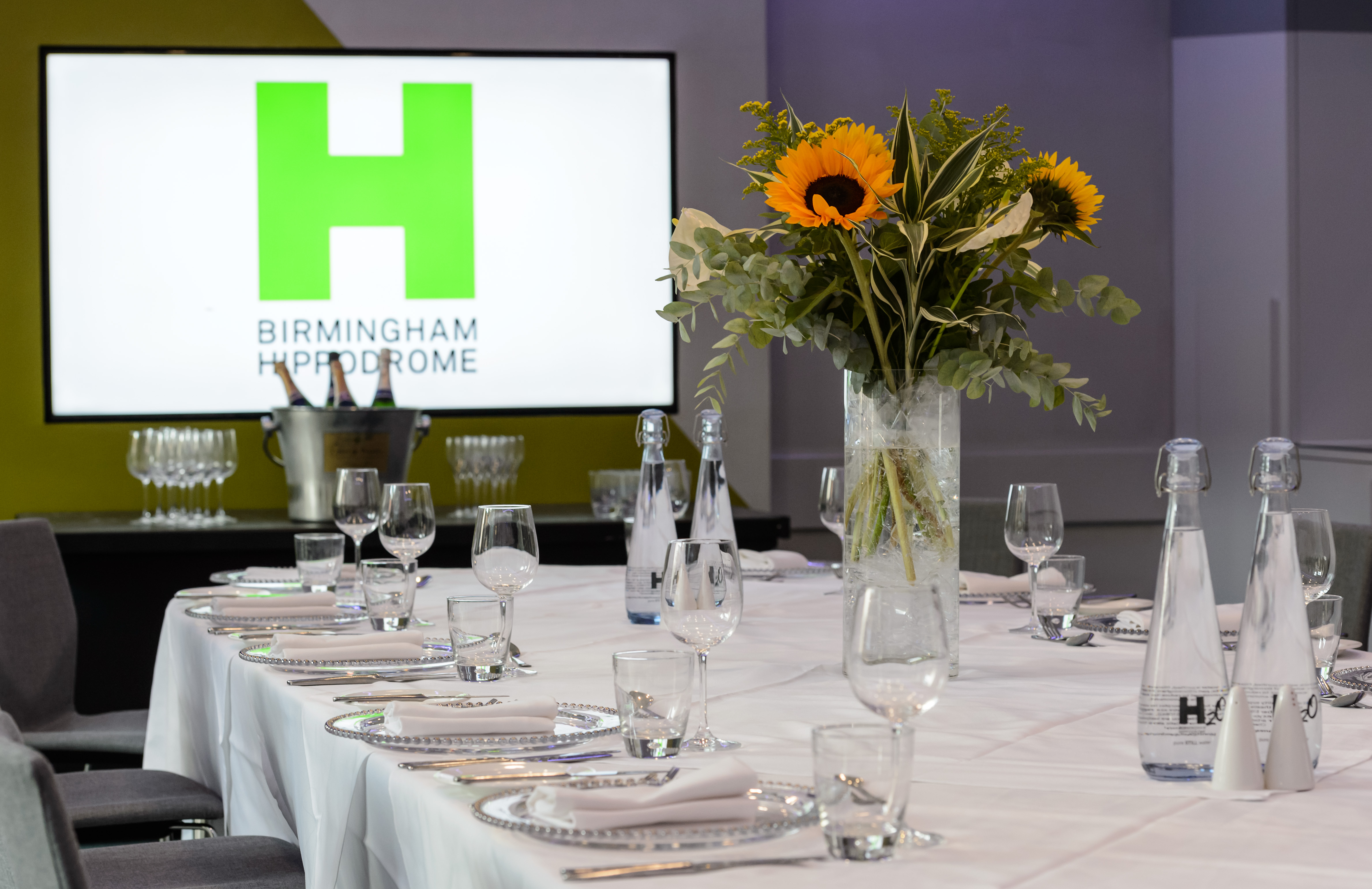 Gowling WLG Suite at Birmingham Hippodrome, elegant table with sunflowers for events.