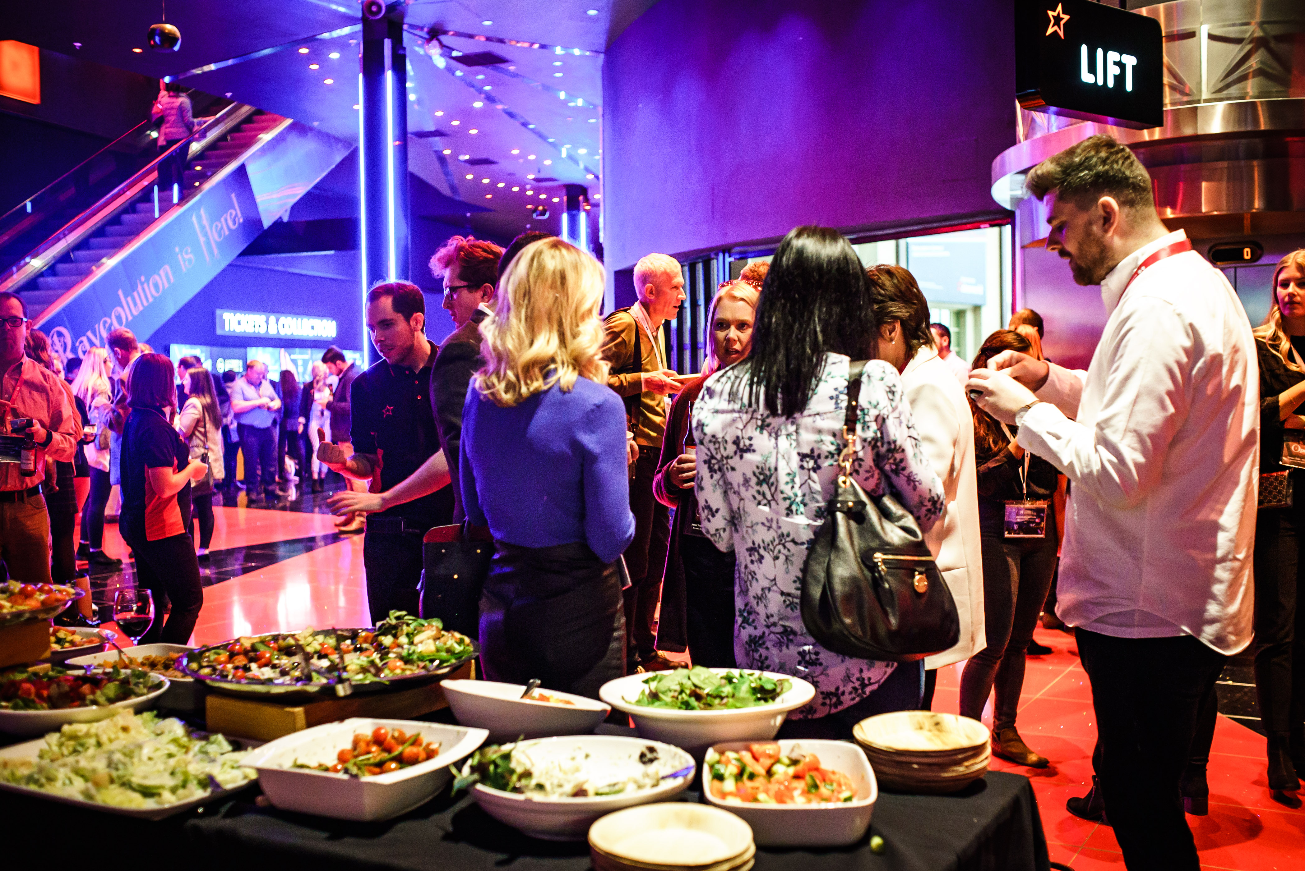 Vibrant networking event at Cineworld O2 Greenwich with diverse food spread and lively atmosphere.