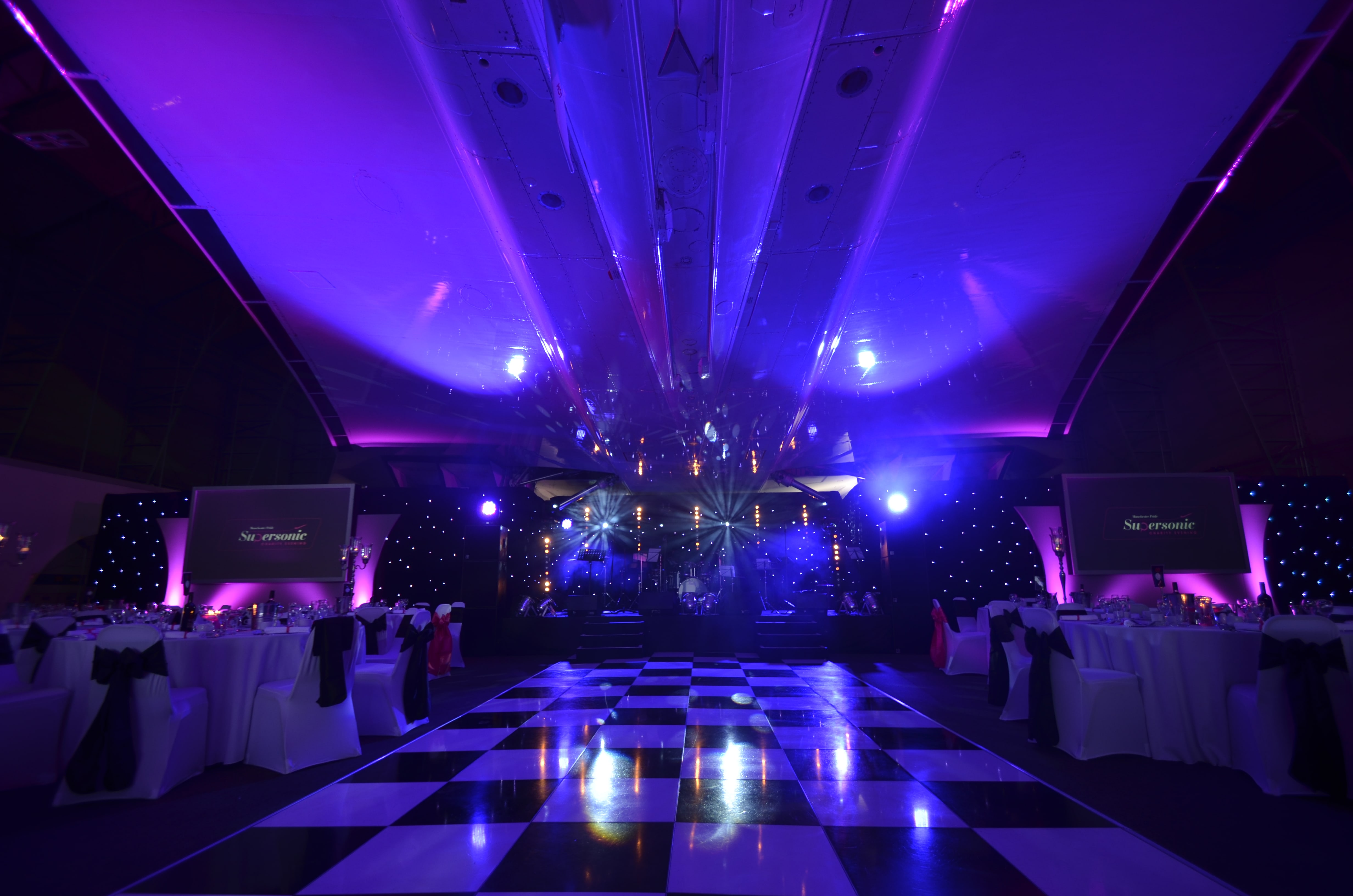 Elegant Christmas party setup at Concorde Conference Centre with dramatic lighting. - Banner