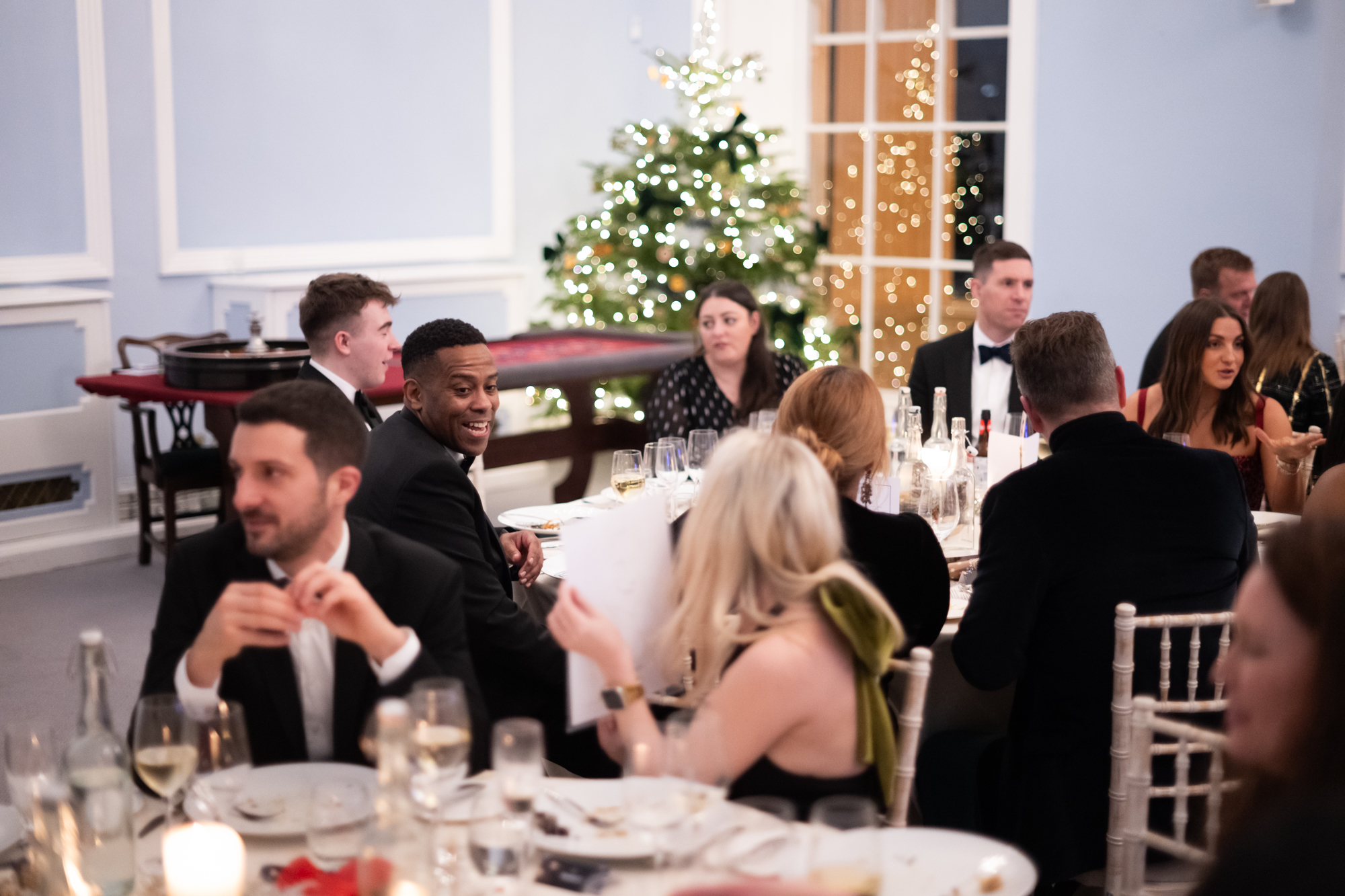 Black-tie Christmas gala in Westminster with festive decor and casino table for holiday parties.