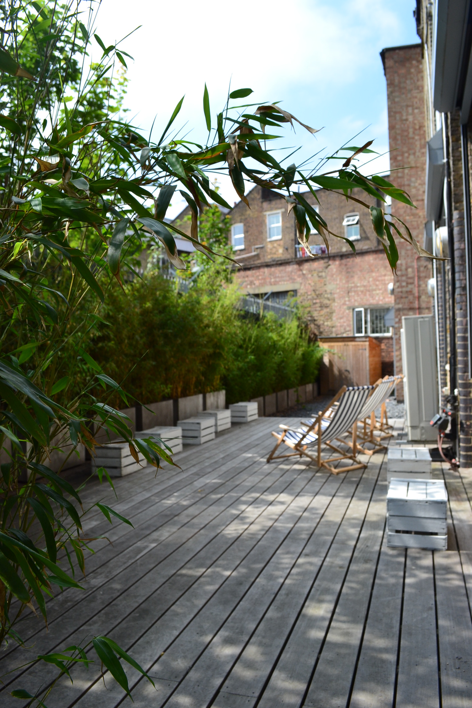 Serene outdoor space with wooden deck for networking events and casual meetings.