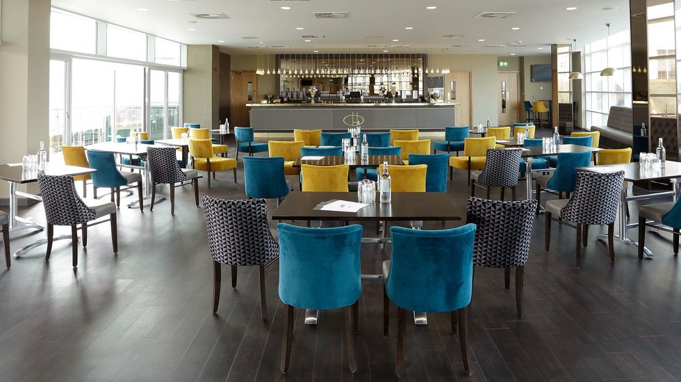 Modern Clubhouse Suite at Leicester Tigers Stadium, vibrant decor for networking events.