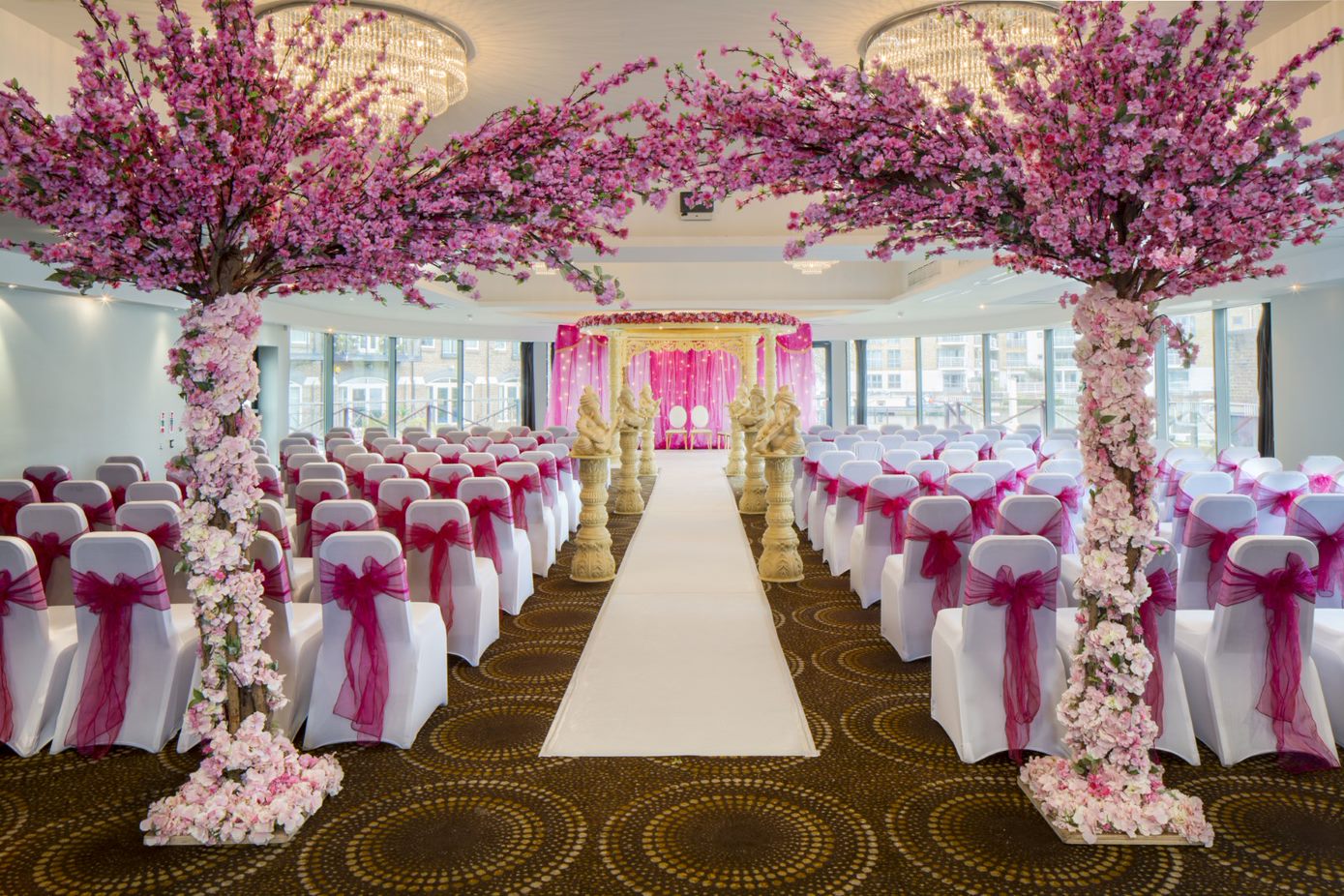 Elegant wedding venue with pink floral decor at The Waterfront Suite, Brentford Lock.