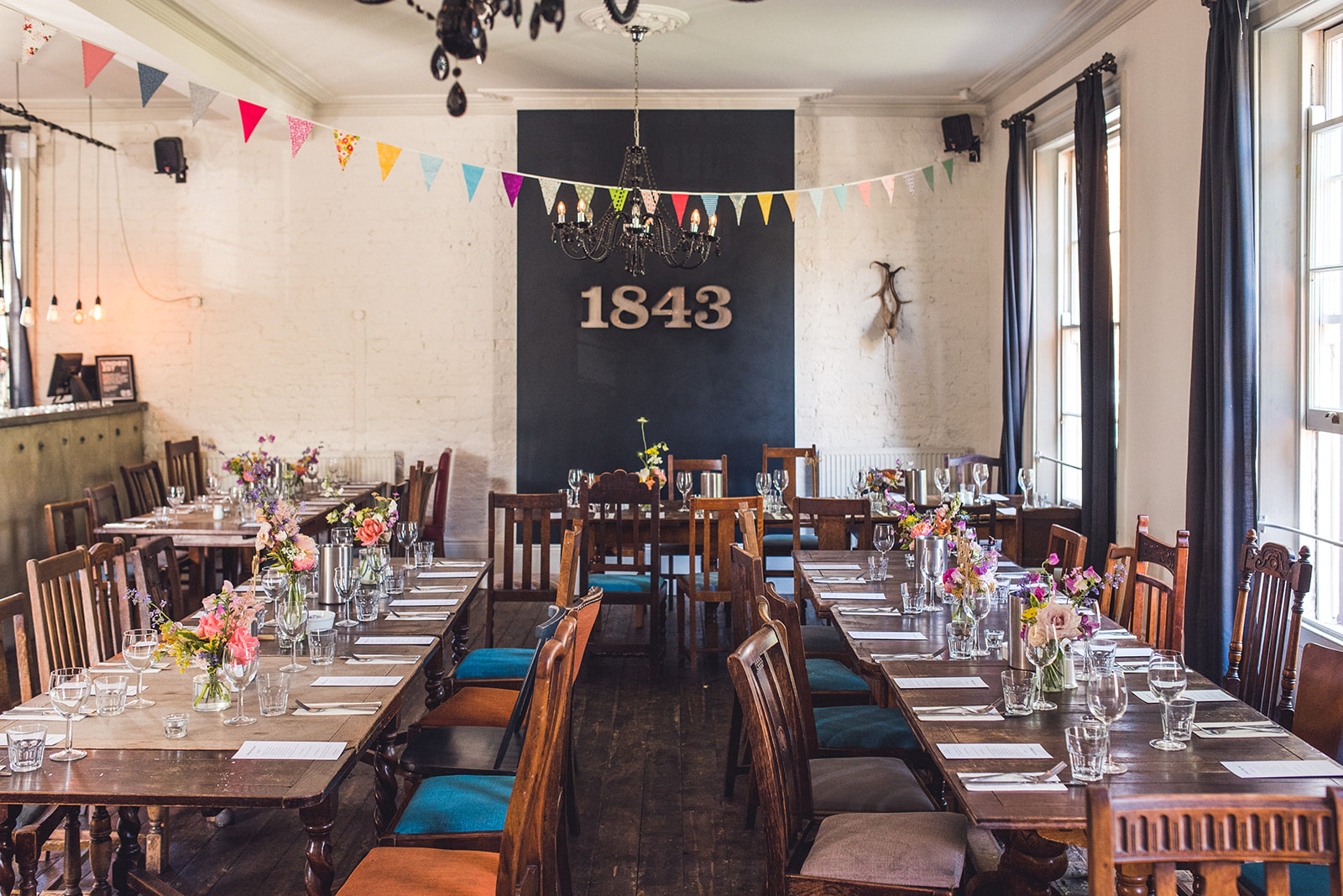 Charming event space with rustic tables and floral decor for gatherings in Camden.