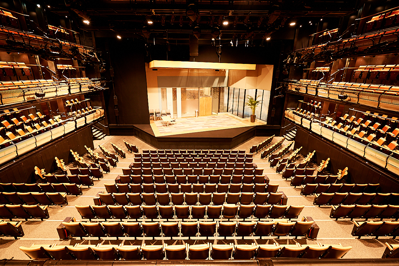 Bridge Theatre auditorium with tiered seating, perfect for conferences and performances. - Banner