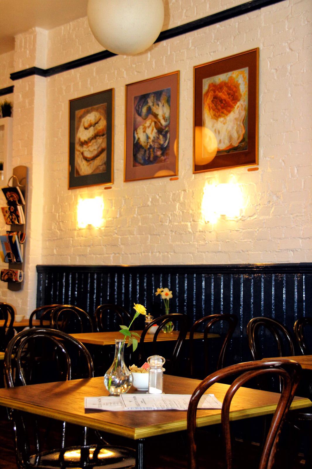 Cozy ground floor restaurant with artistic decor, perfect for intimate meetings and gatherings.
