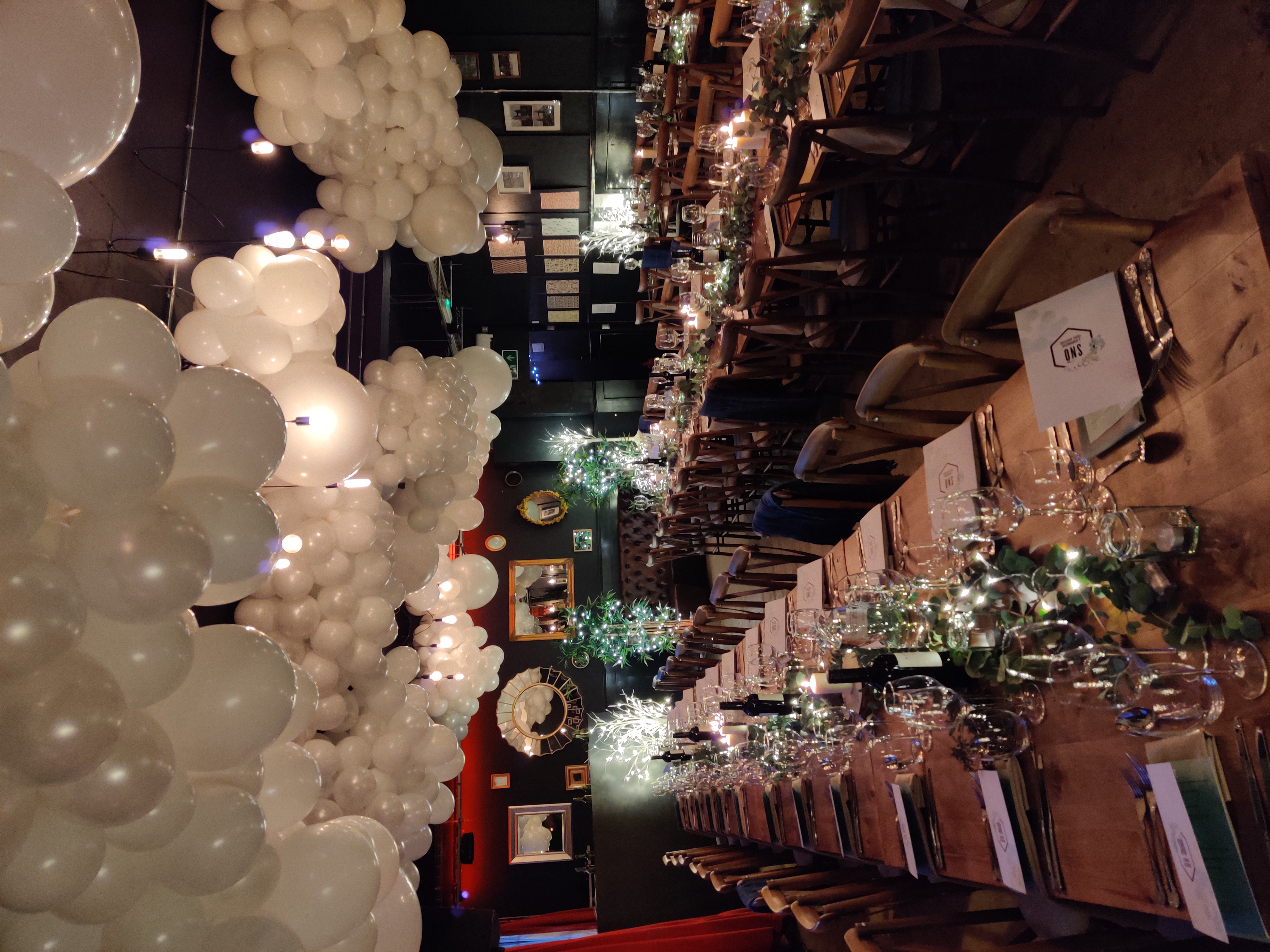 Elegant long table setup in U7 Lounge for upscale dinner events with soft lighting.