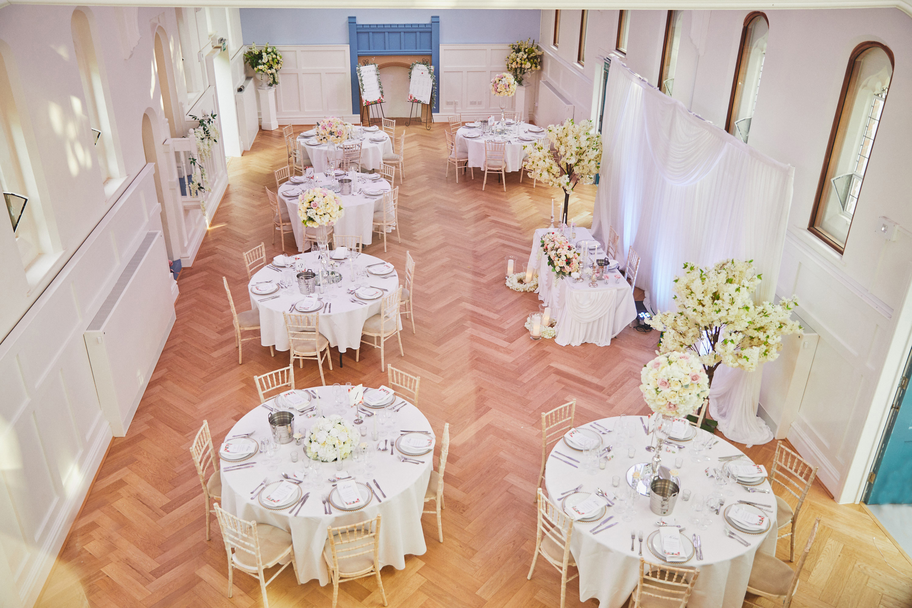 Byculla Suite in Ashburton Hall, Croydon: elegant wedding event space with floral centerpieces.