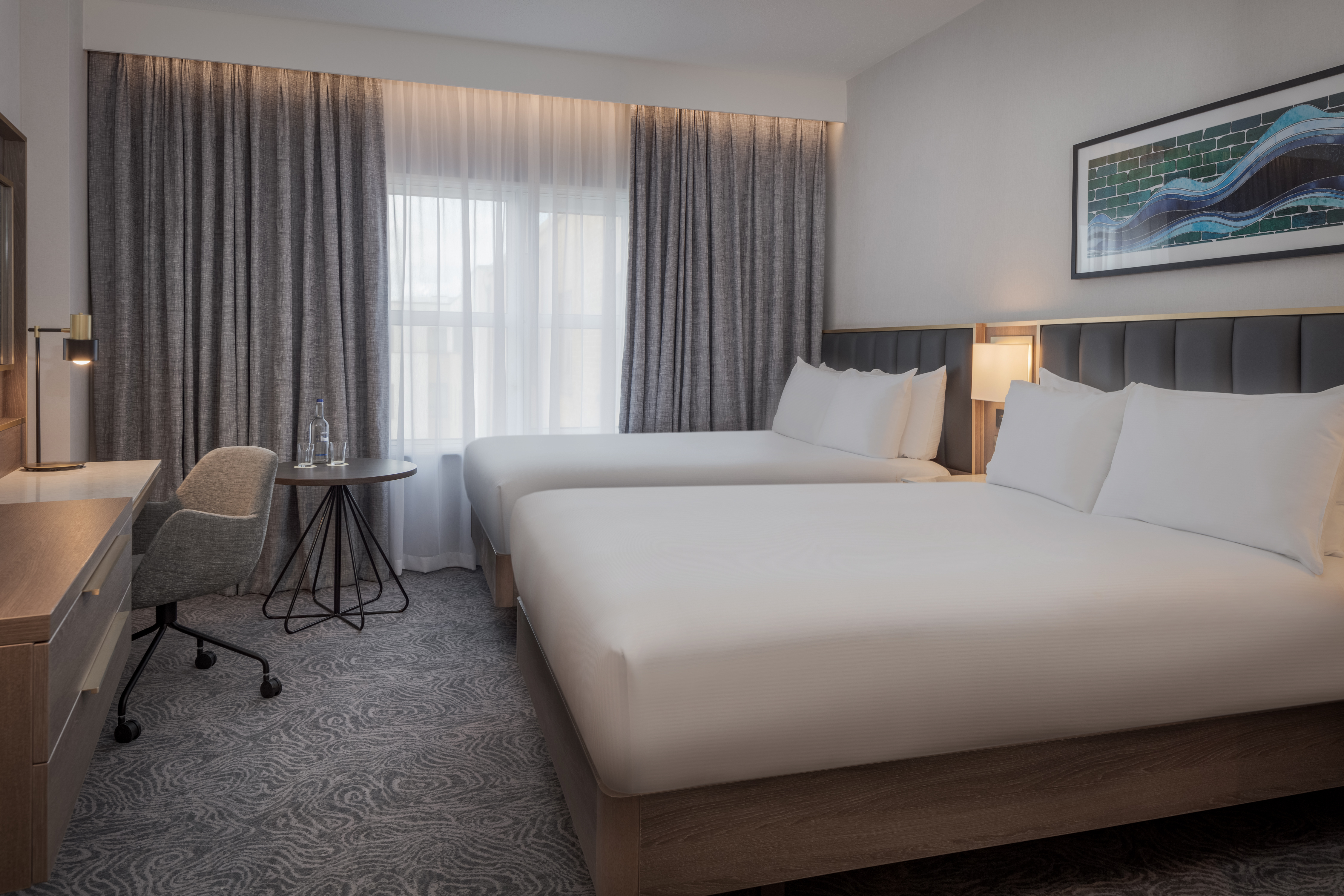 Kings Cross Suite with two beds, ideal for business events and relaxation in London. - Banner