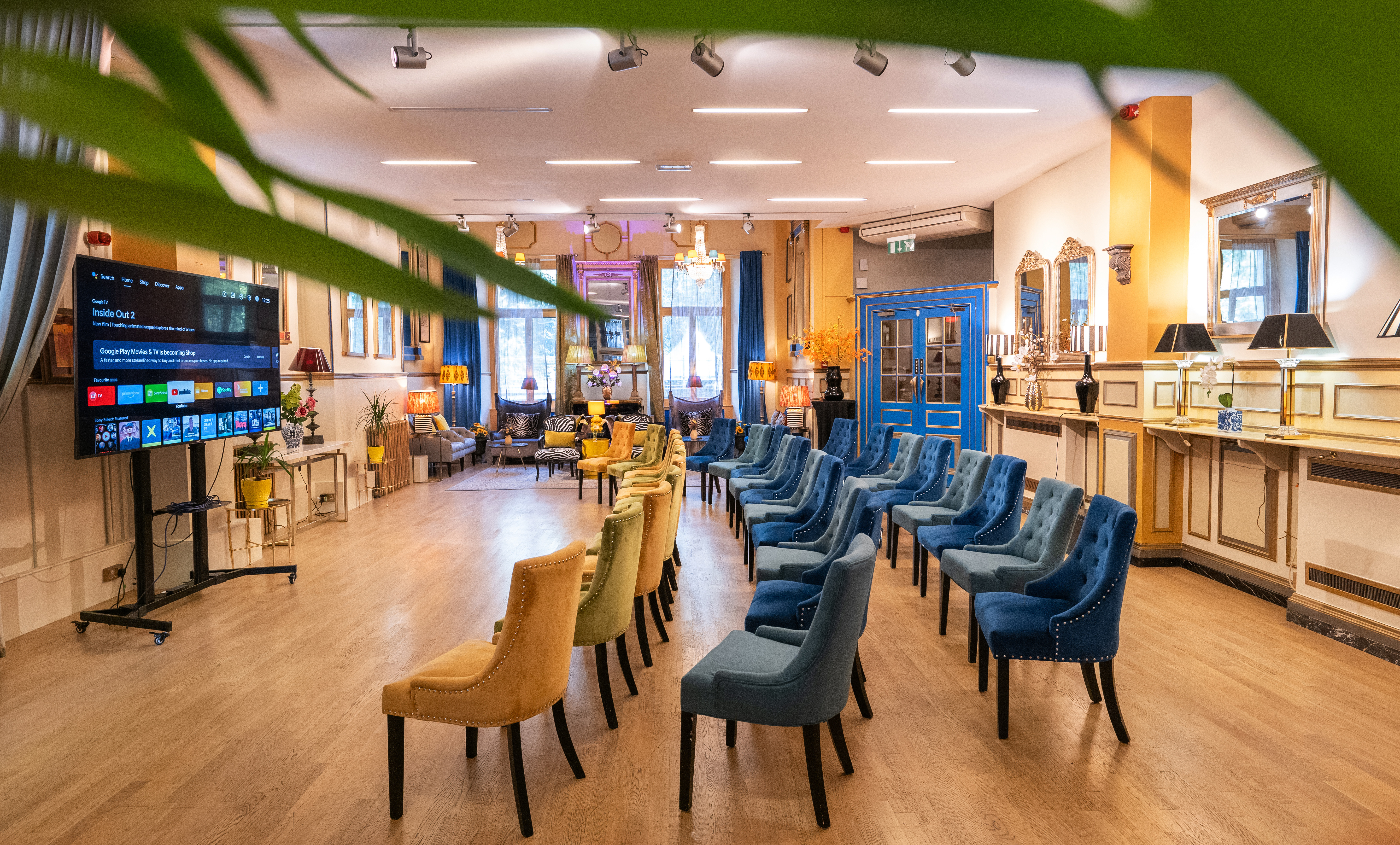 Bright meeting space at The Embassy, featuring colorful chairs for workshops and conferences.