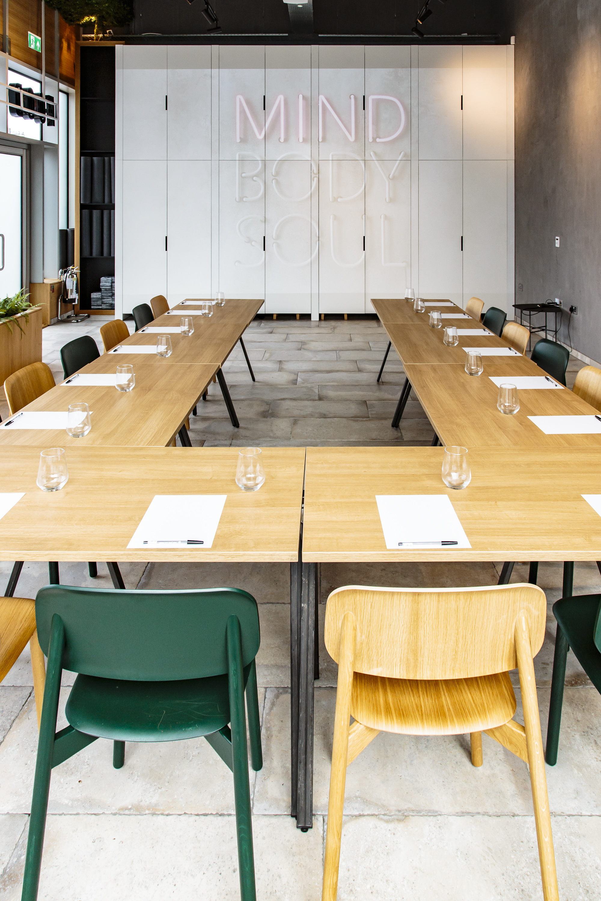 "Professional meeting space with long table, notepads for collaboration events"