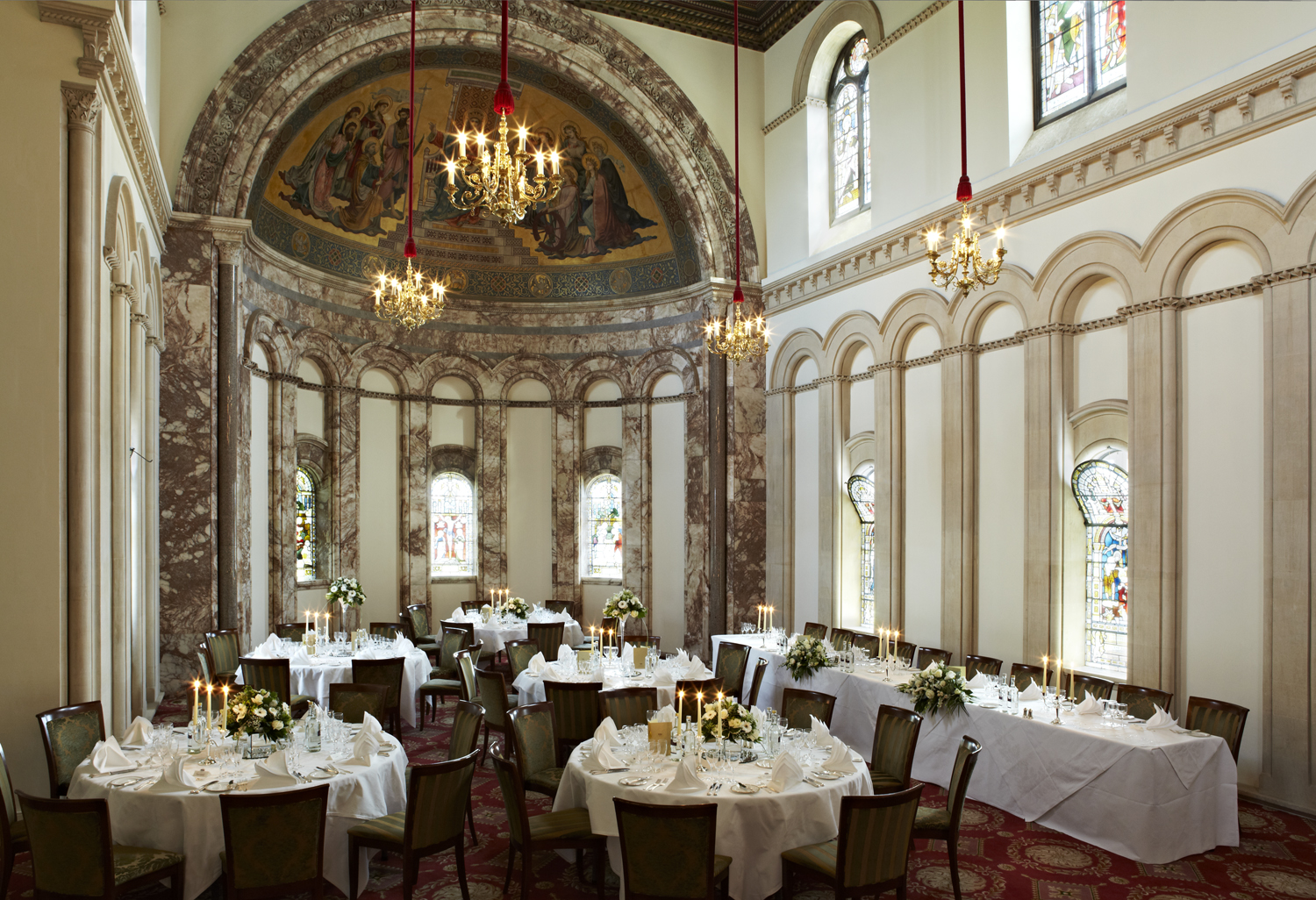 Elegant event space at Luton Hoo Hotel with floral centerpieces for upscale receptions.