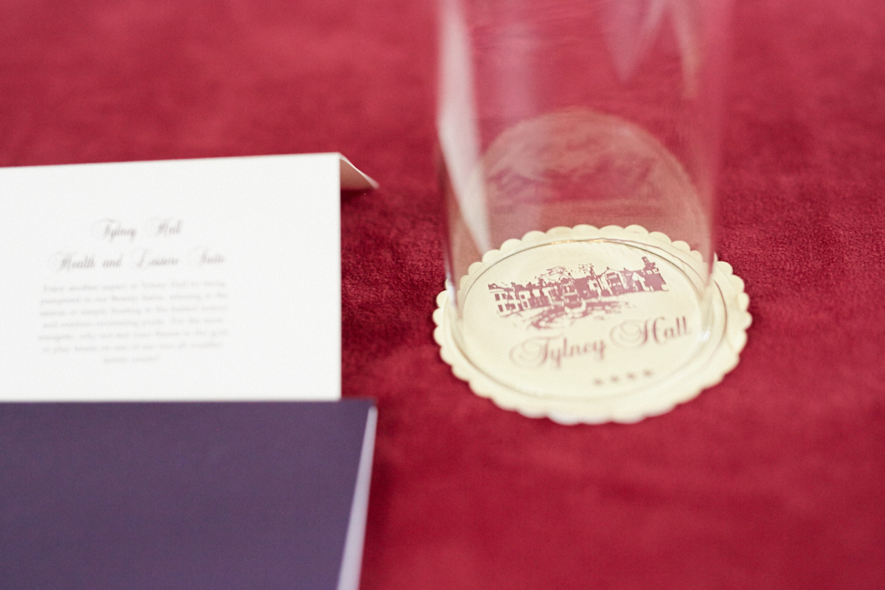 Viscount Castlemaine event setup with elegant stationery and personalized coaster at Tylney Hall.