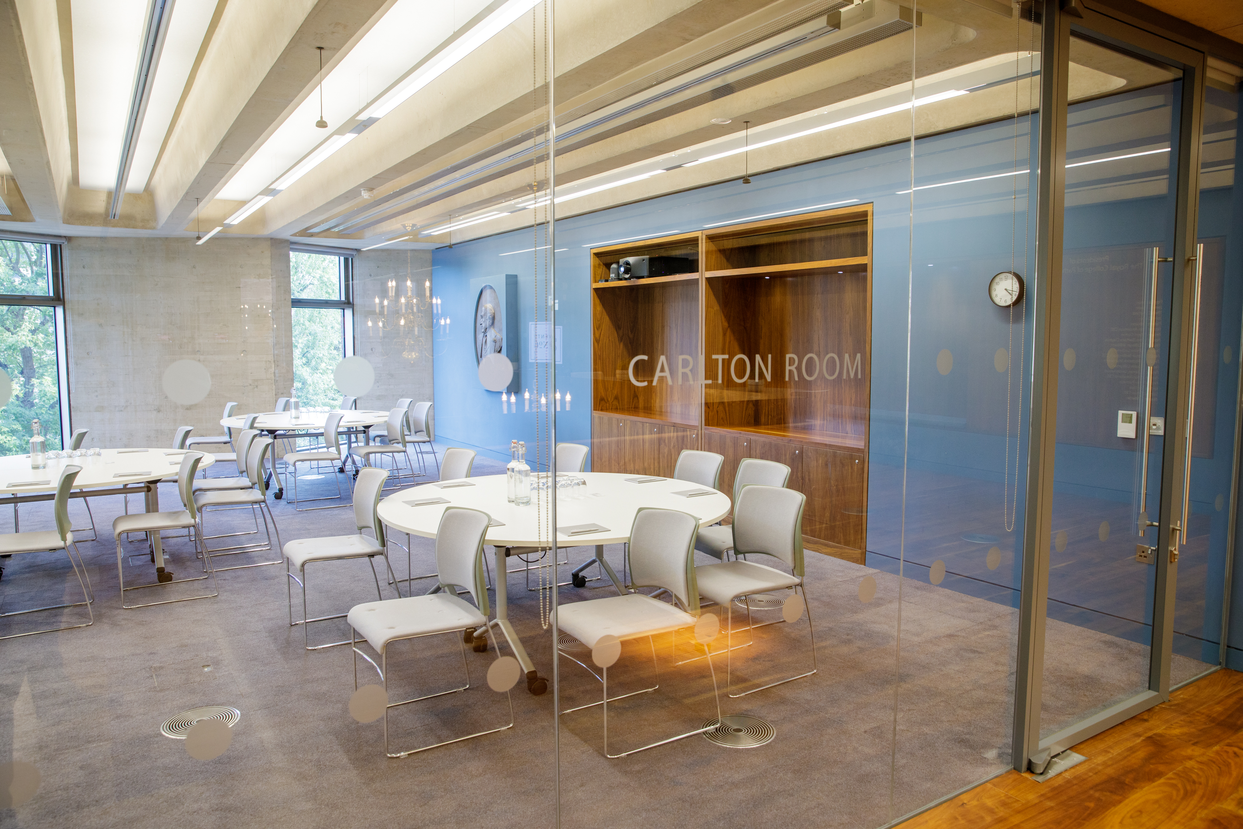 Modern Carlton Room with round tables, ideal for meetings and events at No 6.