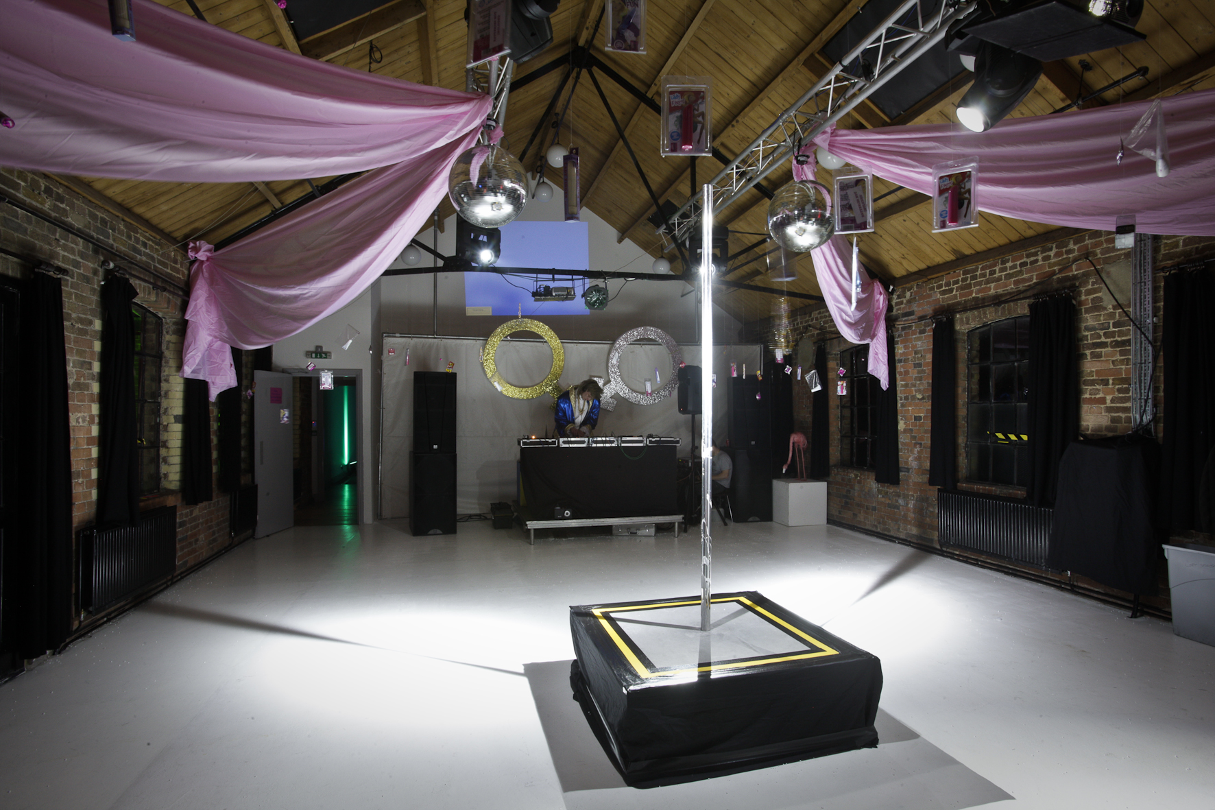 Versatile event space with polished dance floor, ideal for parties and themed events.