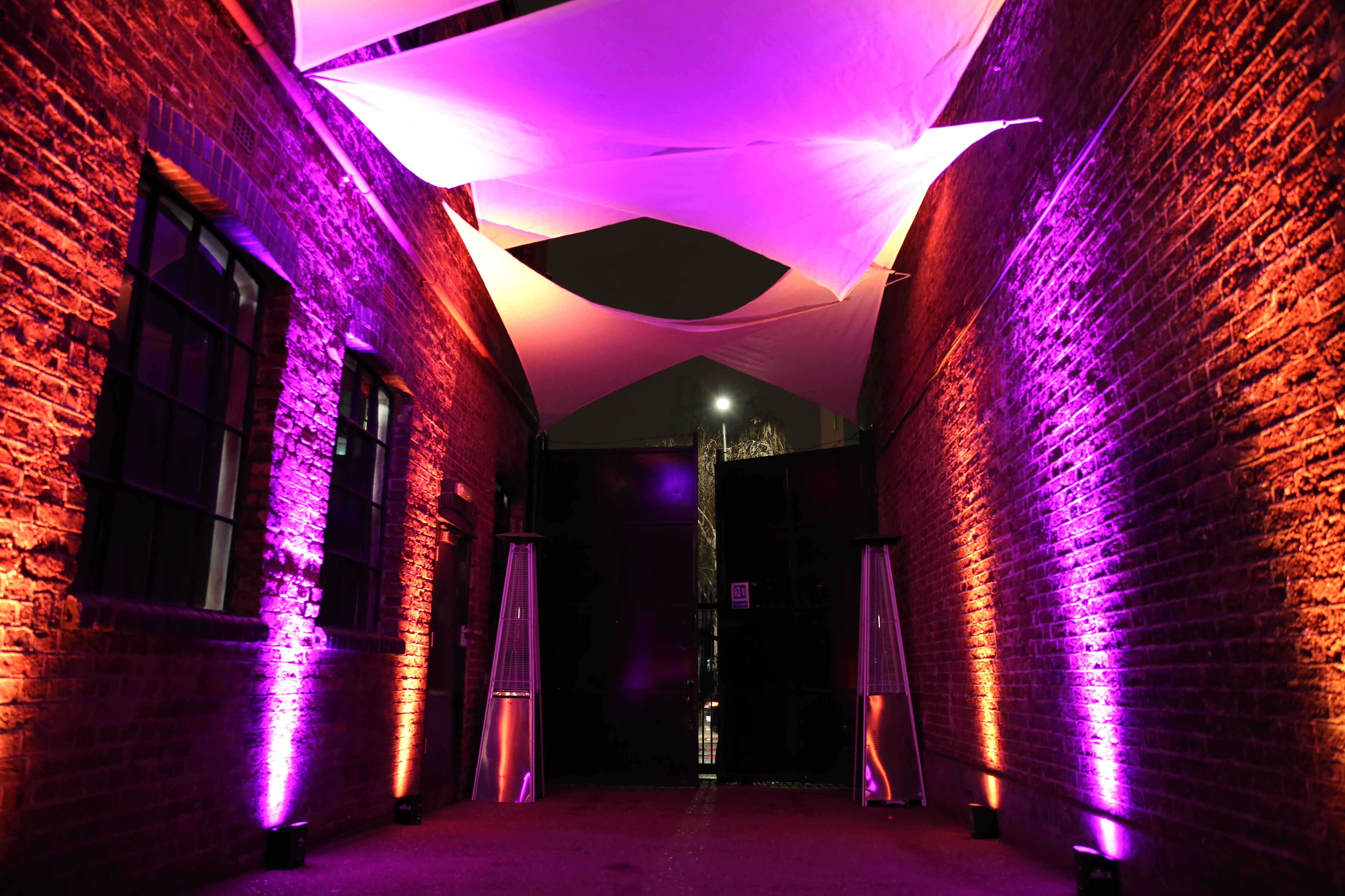 Stylish entrance of Daylight Courtyard at Loft Studios with dramatic lighting for events.