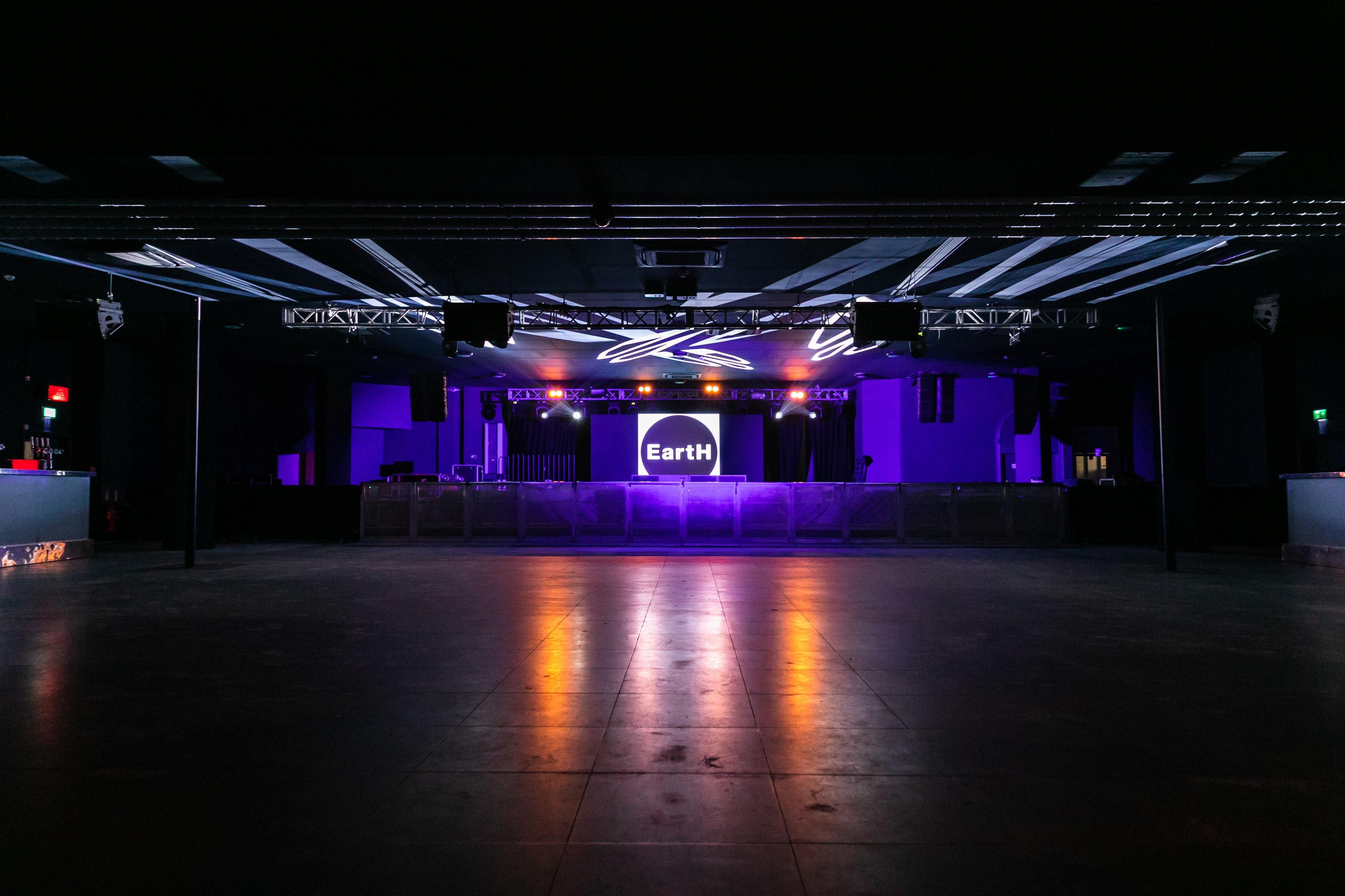 Modern Concert Hall with vibrant purple lighting, ideal for events and concerts.