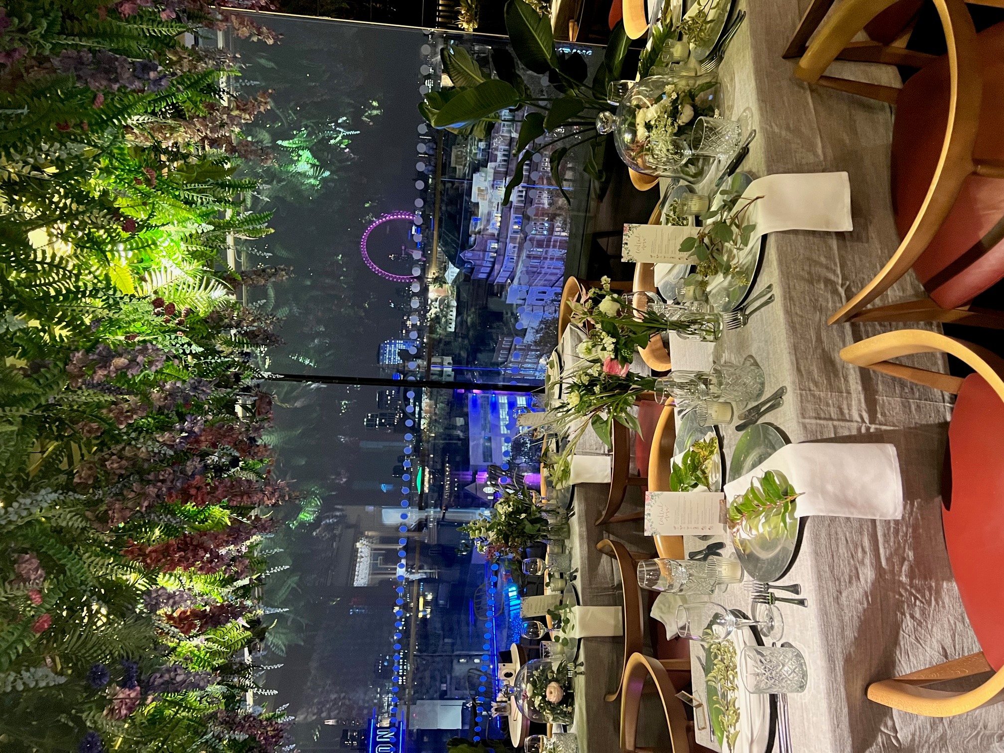 Elegant dining table with floral arrangements at LSQ Rooftop, perfect for upscale events.