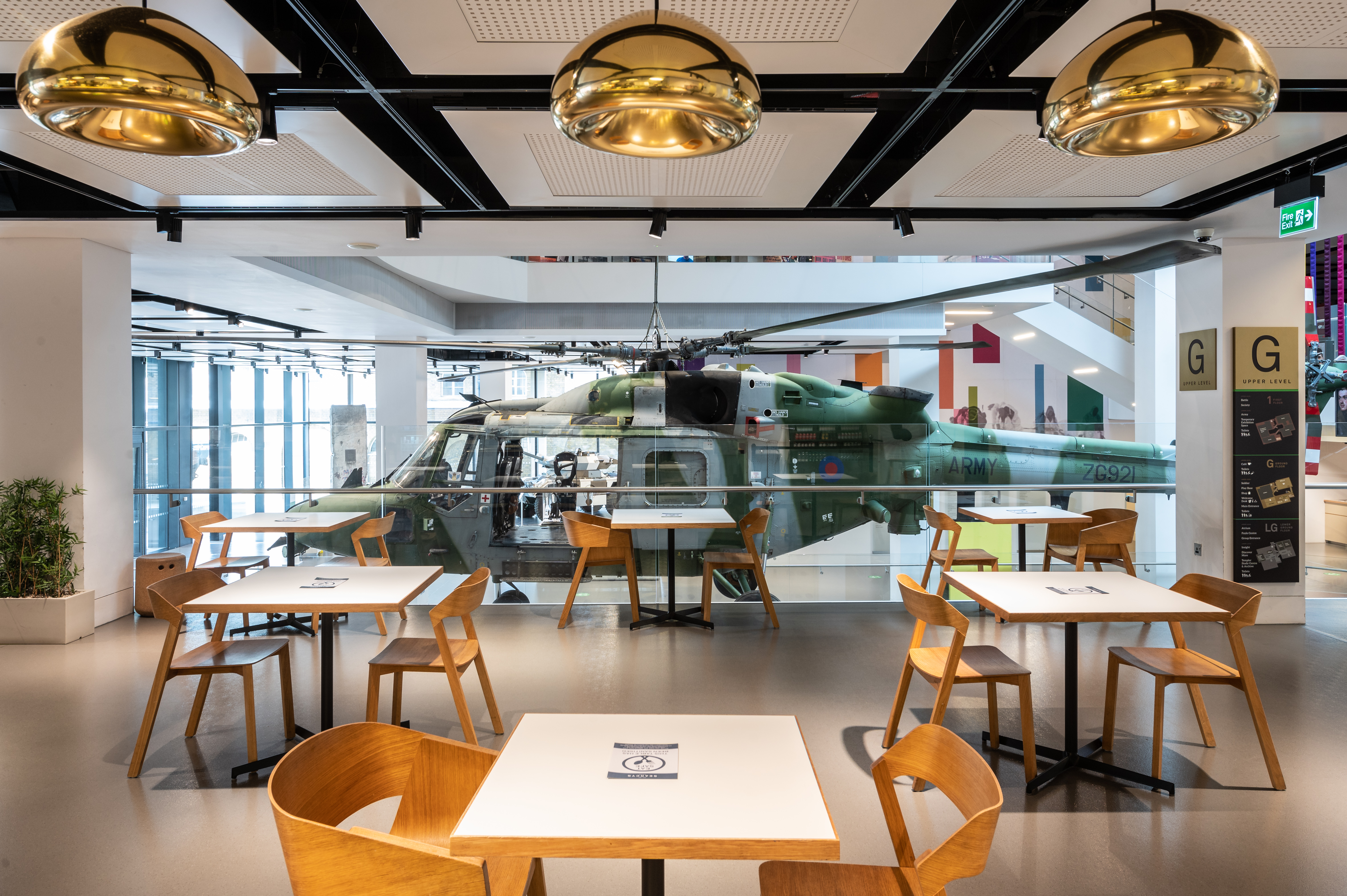 Modern cafe event space with helicopter display for corporate meetings and networking.