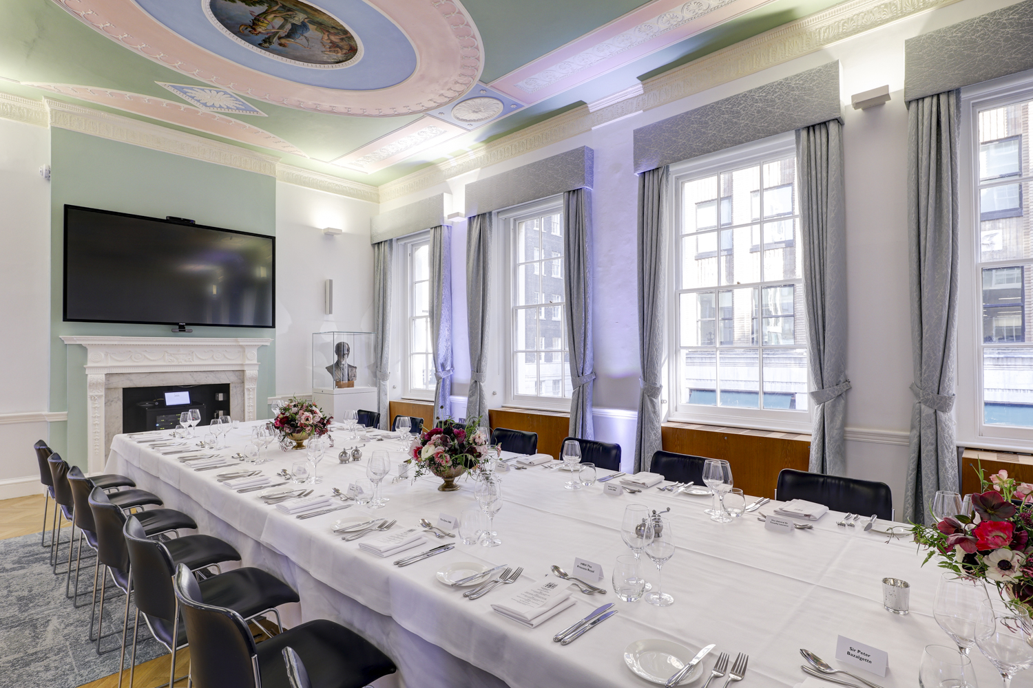 Elegant meeting room in RSA House with floral centerpieces, ideal for corporate events.