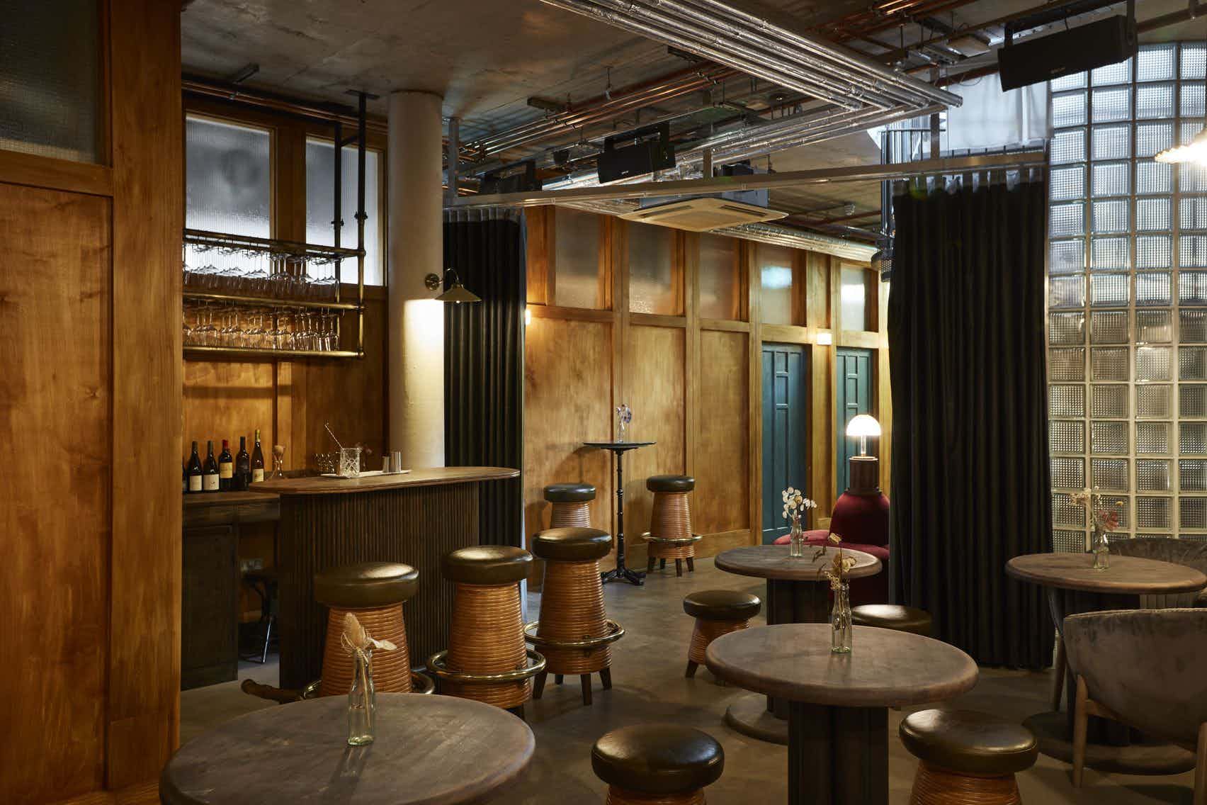 Stylish Downstairs bar in Lino with warm wood accents for intimate events and meetings. - Banner