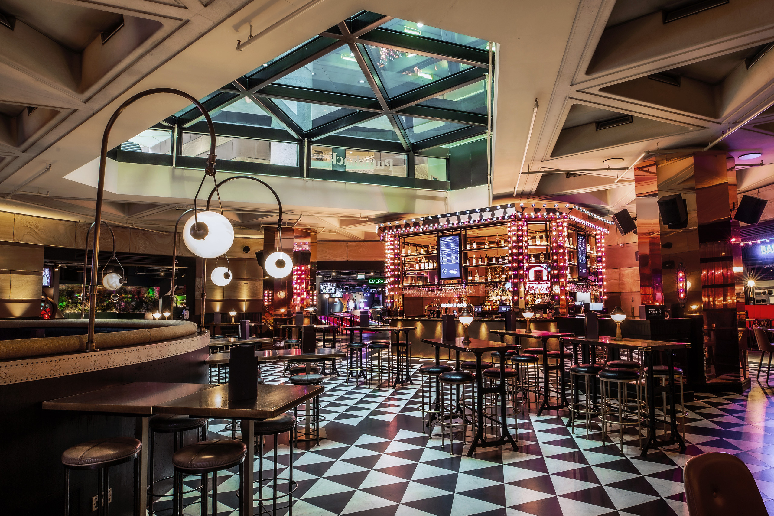 Stylish venue with geometric floor, ideal for networking events and social gatherings.