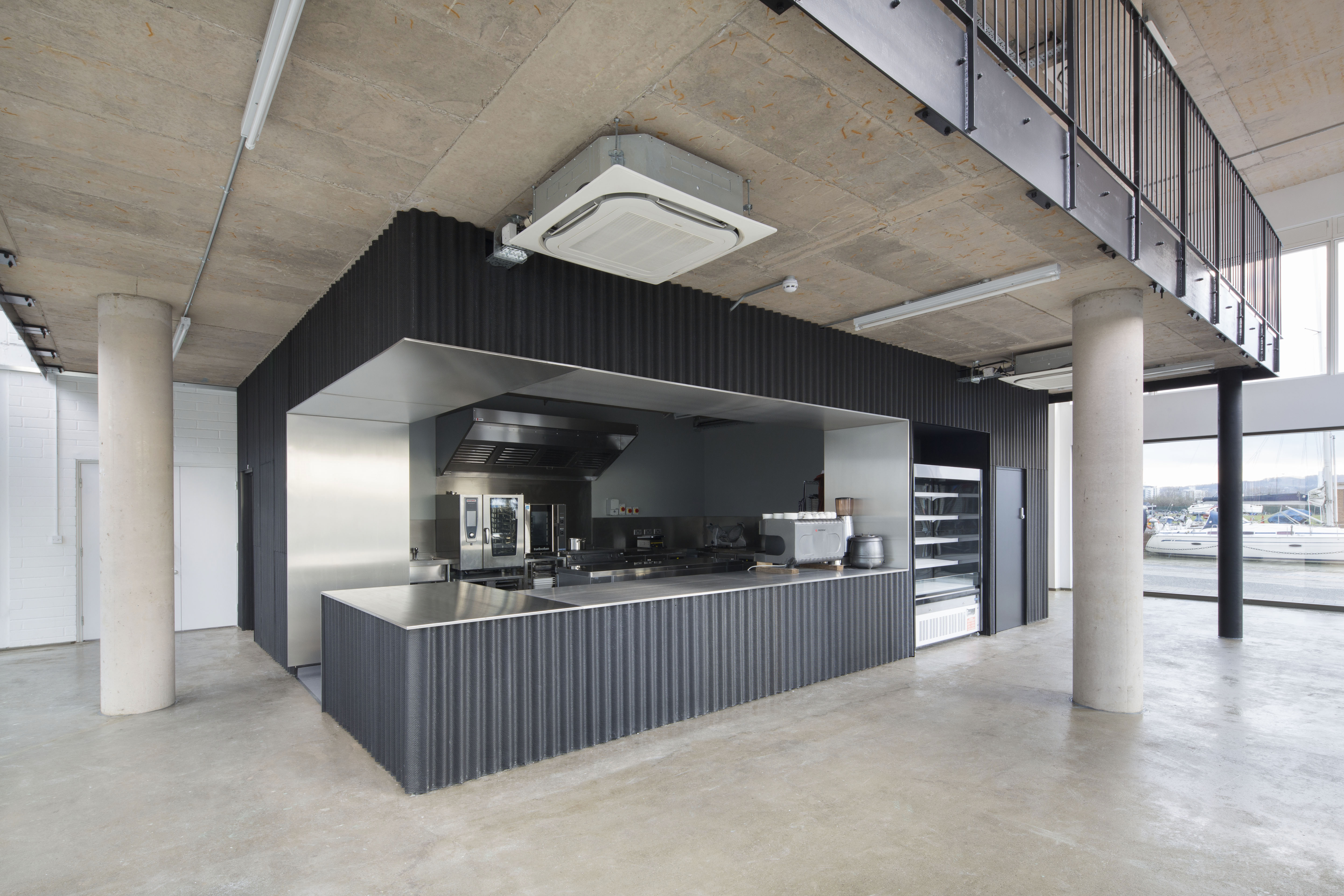 Modern industrial kitchen with stainless steel surfaces for catering events.