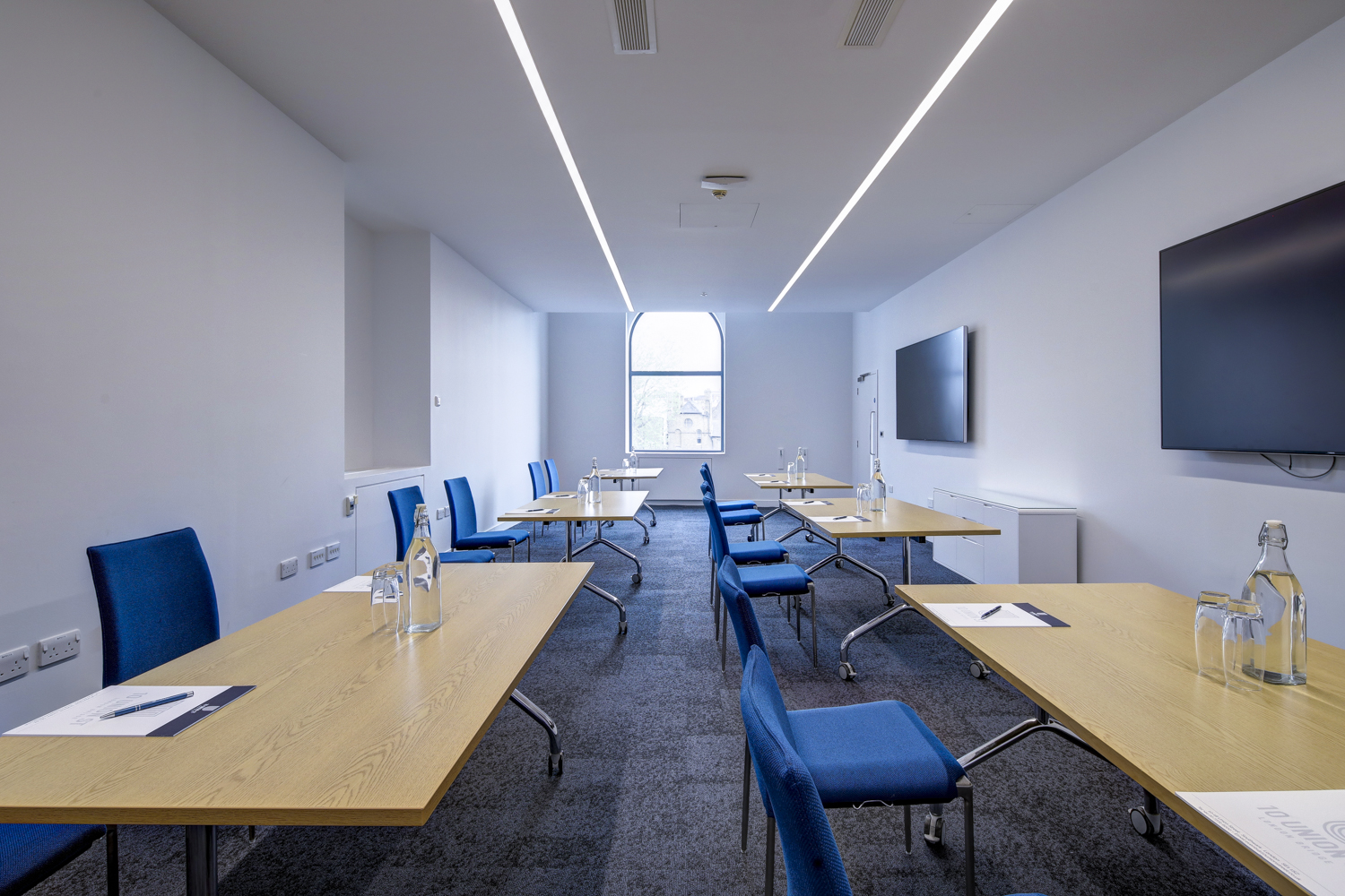 Modern meeting room 303 at 10 Union St. with ergonomic chairs for corporate events.