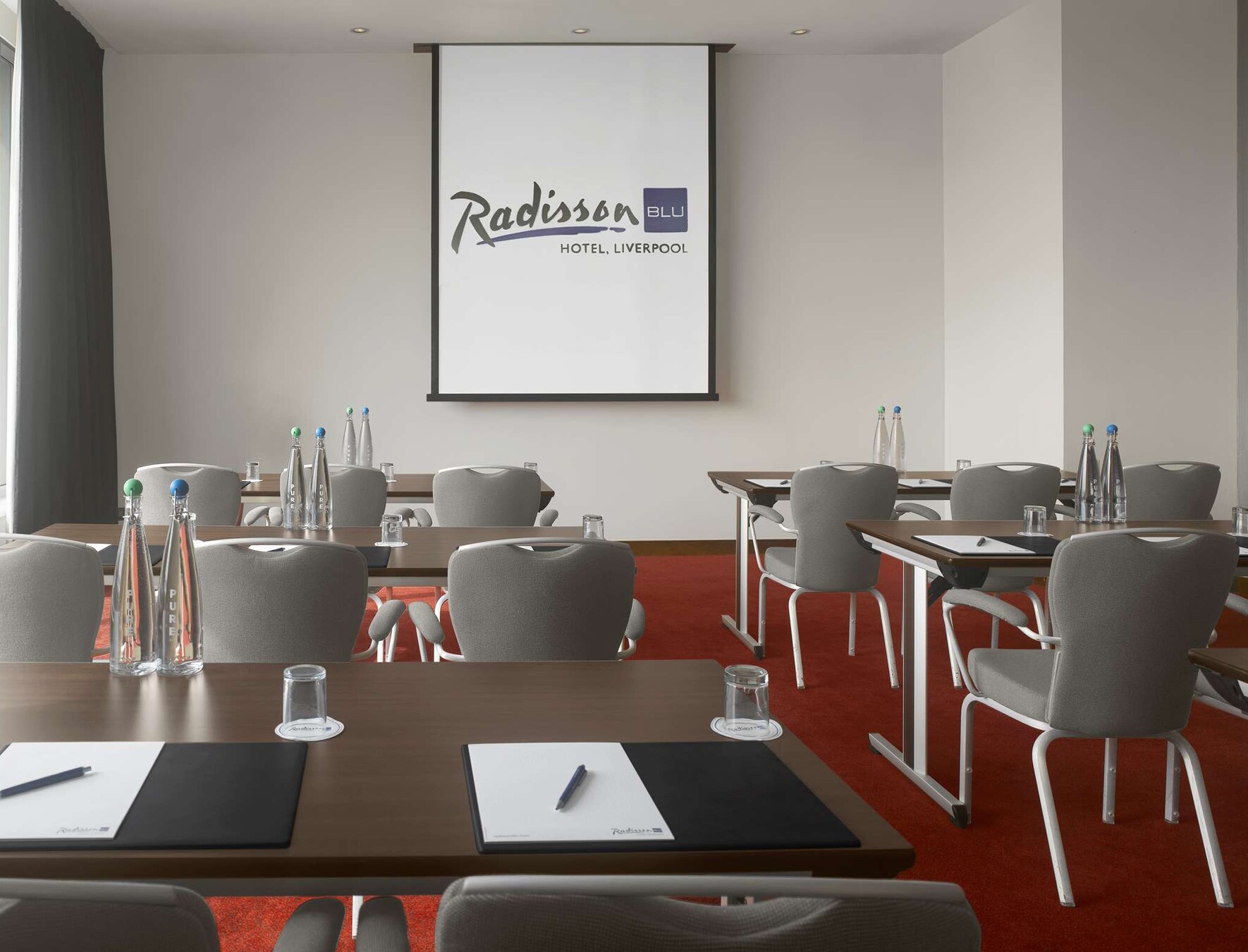 Well-organized meeting room at Radisson Blu Liverpool with modern furniture for corporate events.