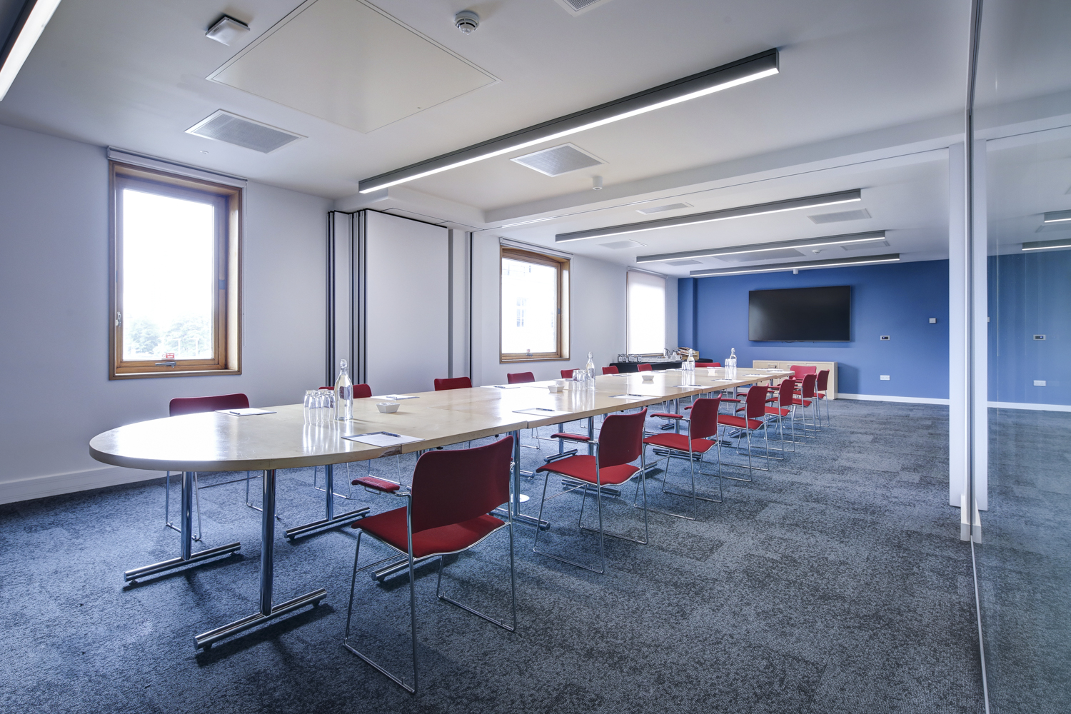 Modern meeting room, oval table, event space, corporate training