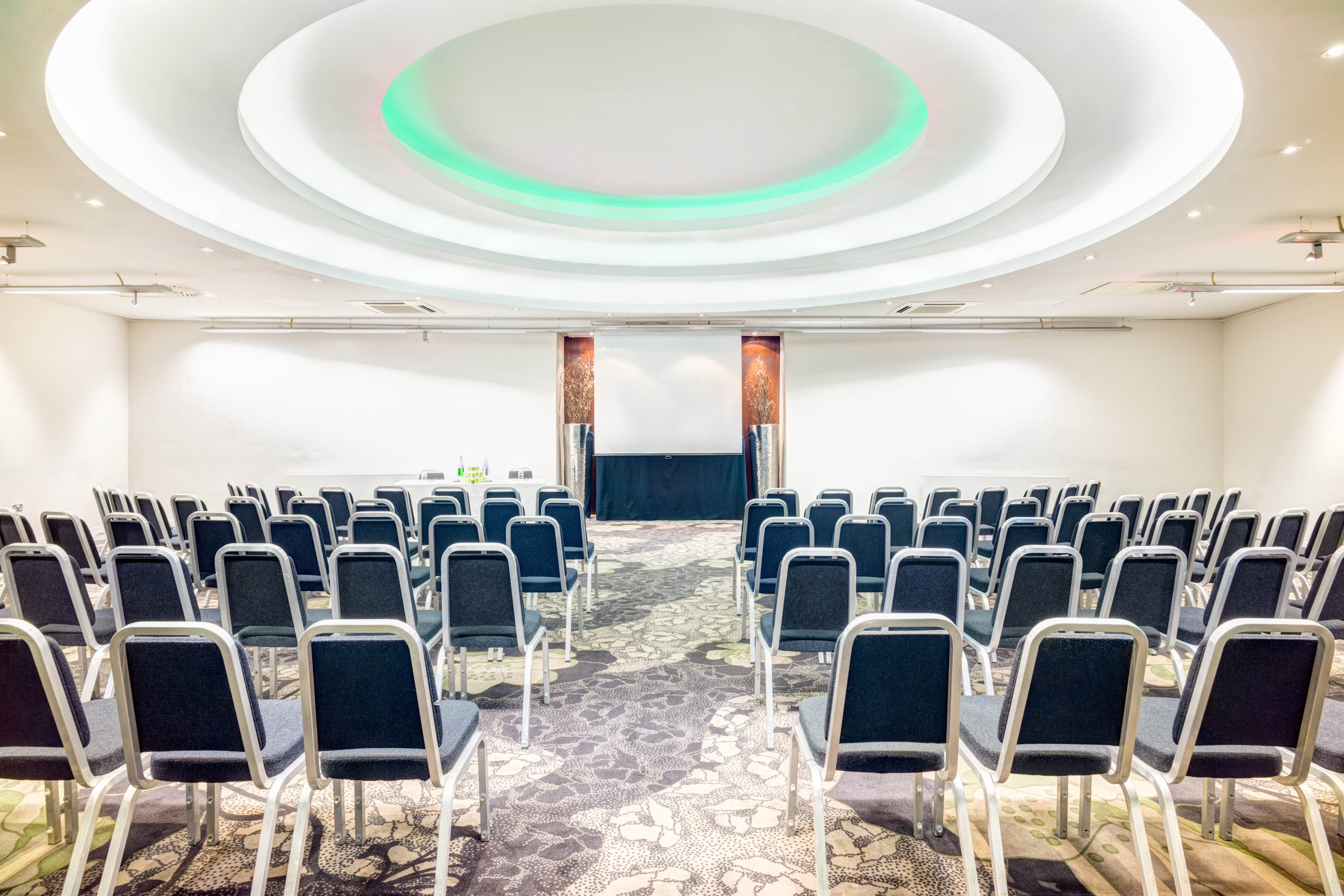 Apex Suite meeting space with elegant lighting, ideal for presentations and workshops.