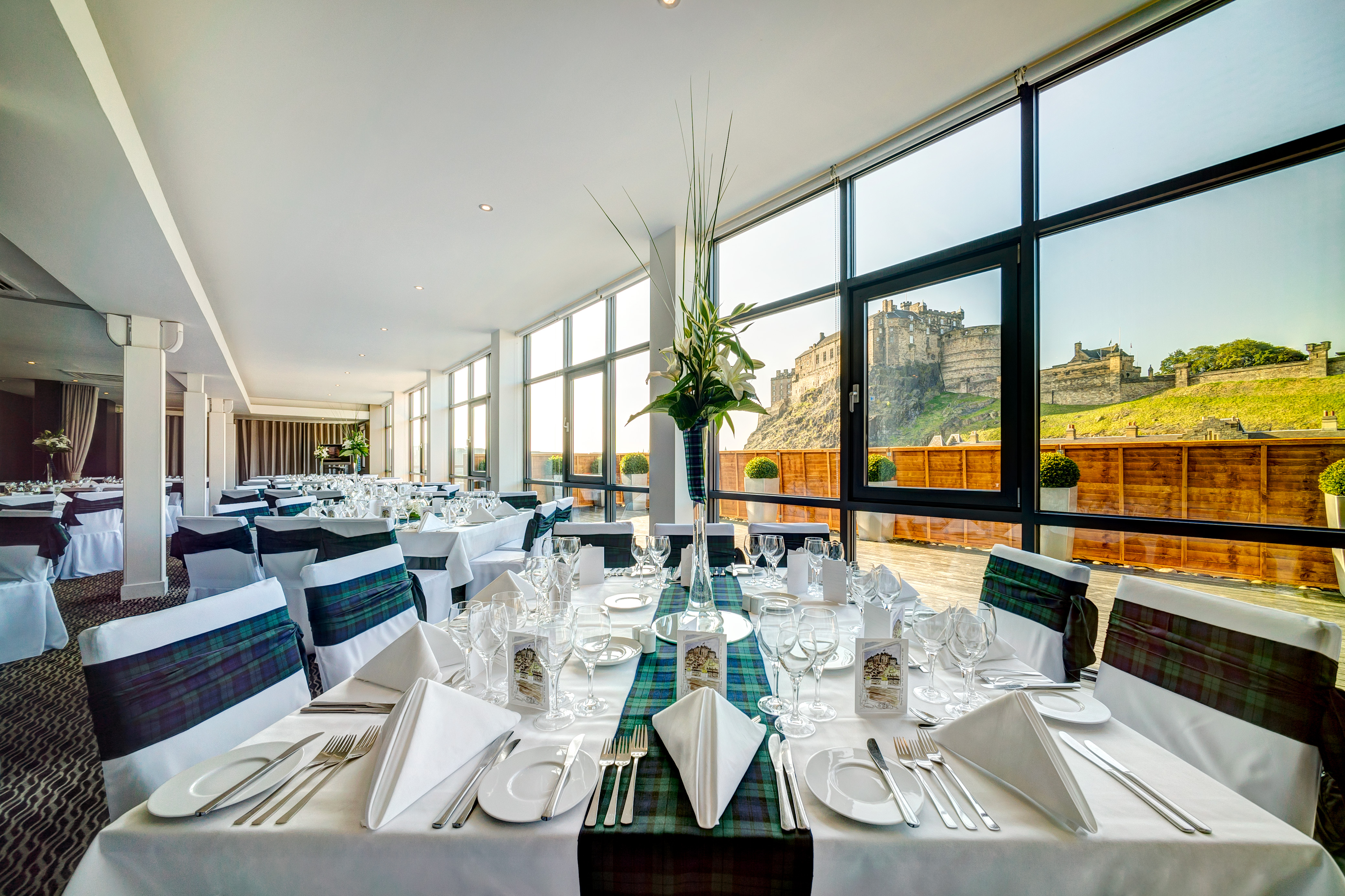Elegant dining area at Apex Grassmarket Hotel with castle view for weddings and events.