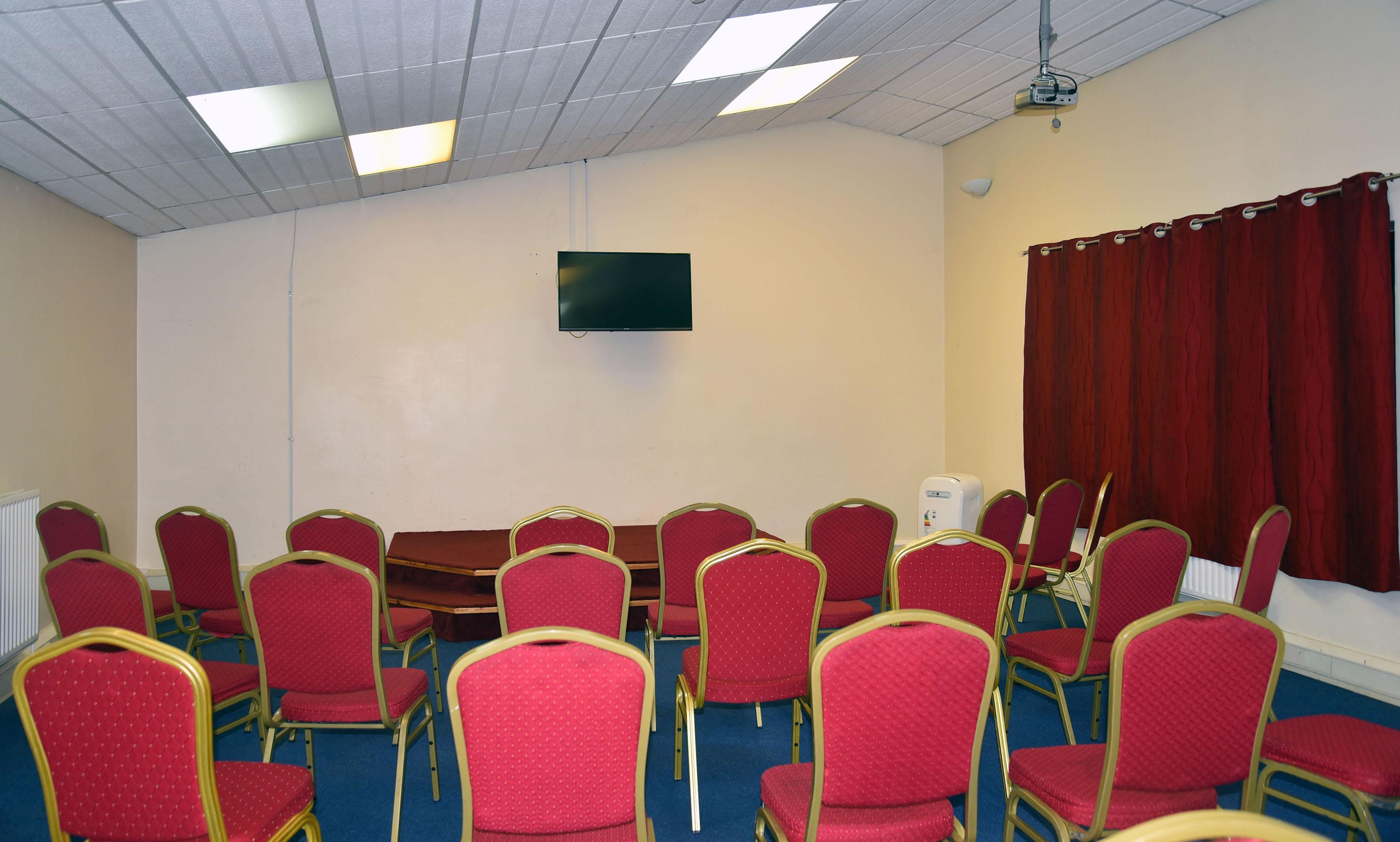 Mitcham Business Event Centre meeting room with red chairs, ideal for workshops and gatherings.