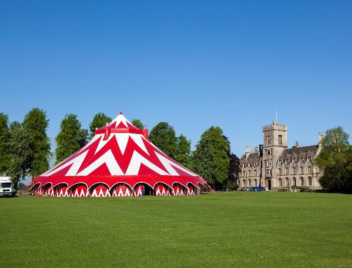 Vibrant red and white striped tent at Royal Agricultural University for outdoor events.