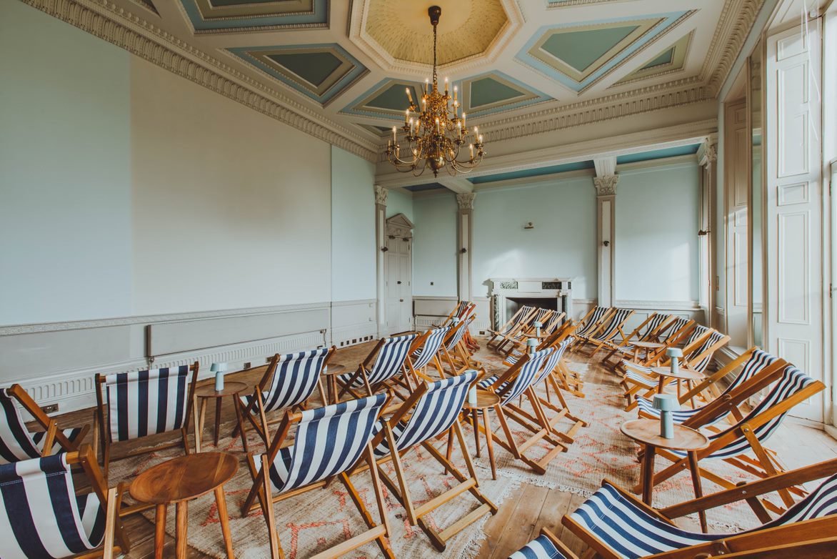 Stylish Screening Room with deck chairs for creative brainstorming and networking events.