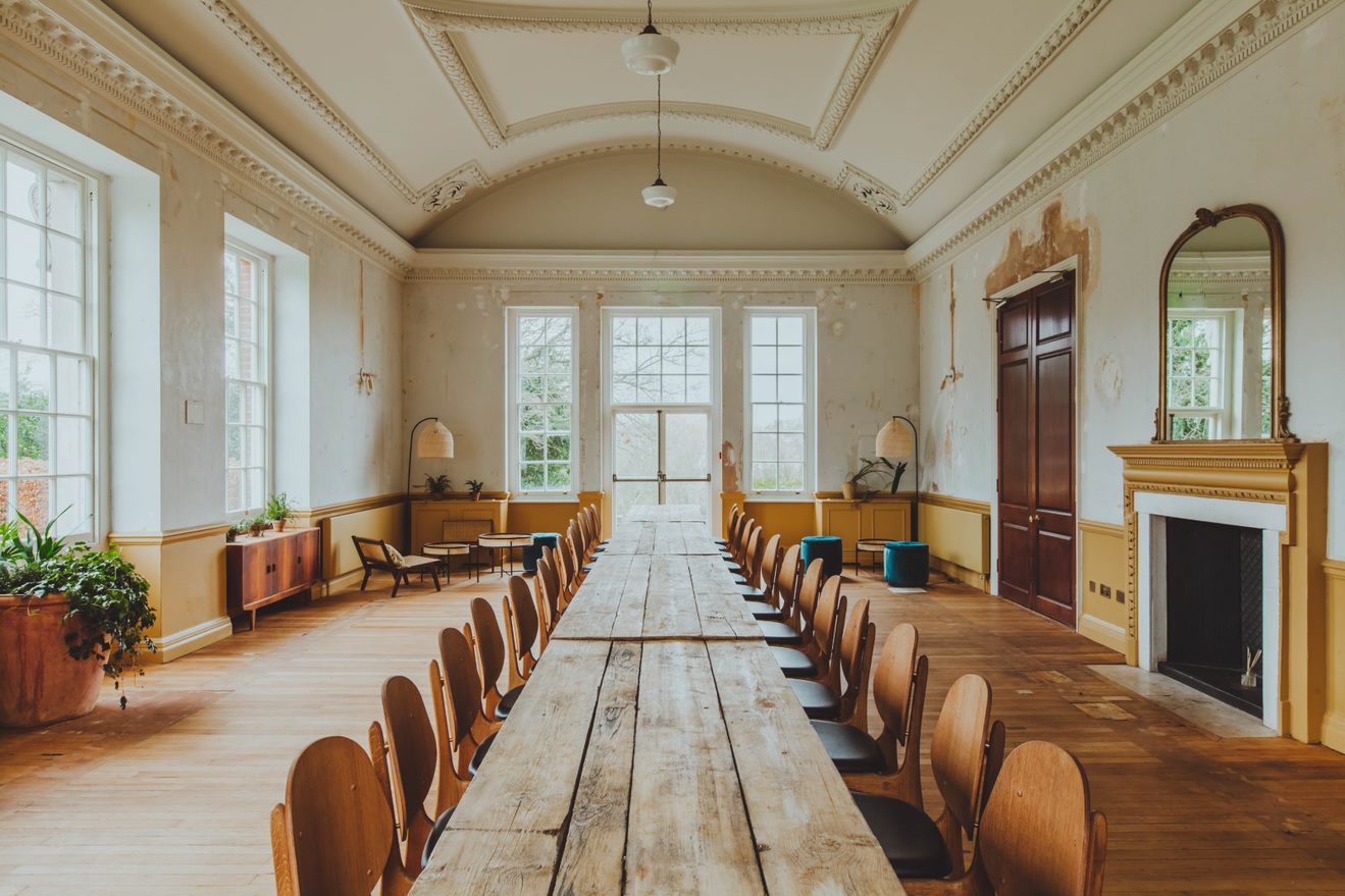 Spacious meeting room with large windows, ideal for collaborative discussions and brainstorming.