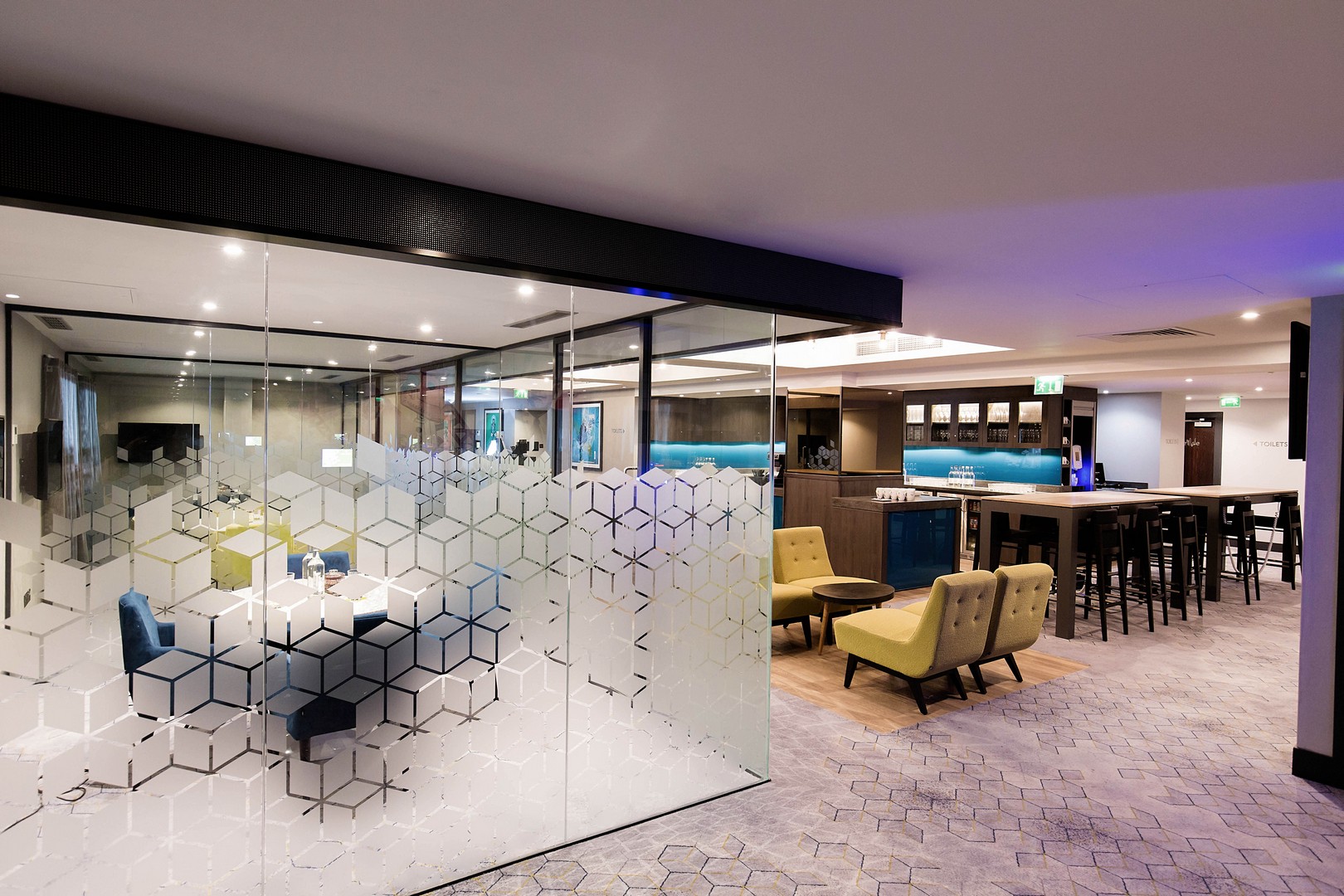 Modern meeting space in Malmaison Birmingham with glass walls for collaboration and networking.