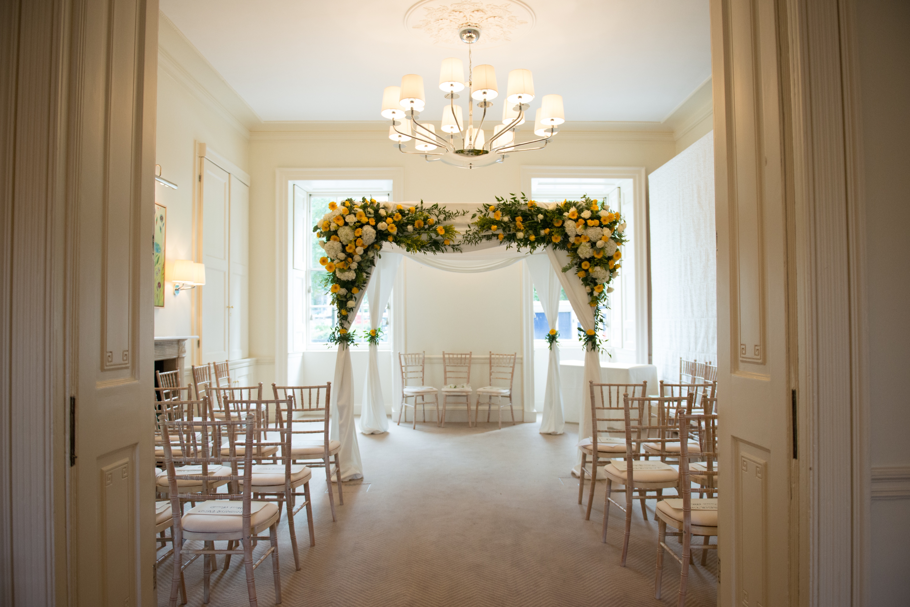 Elegant Garden Room with floral arch, perfect for weddings and intimate events.