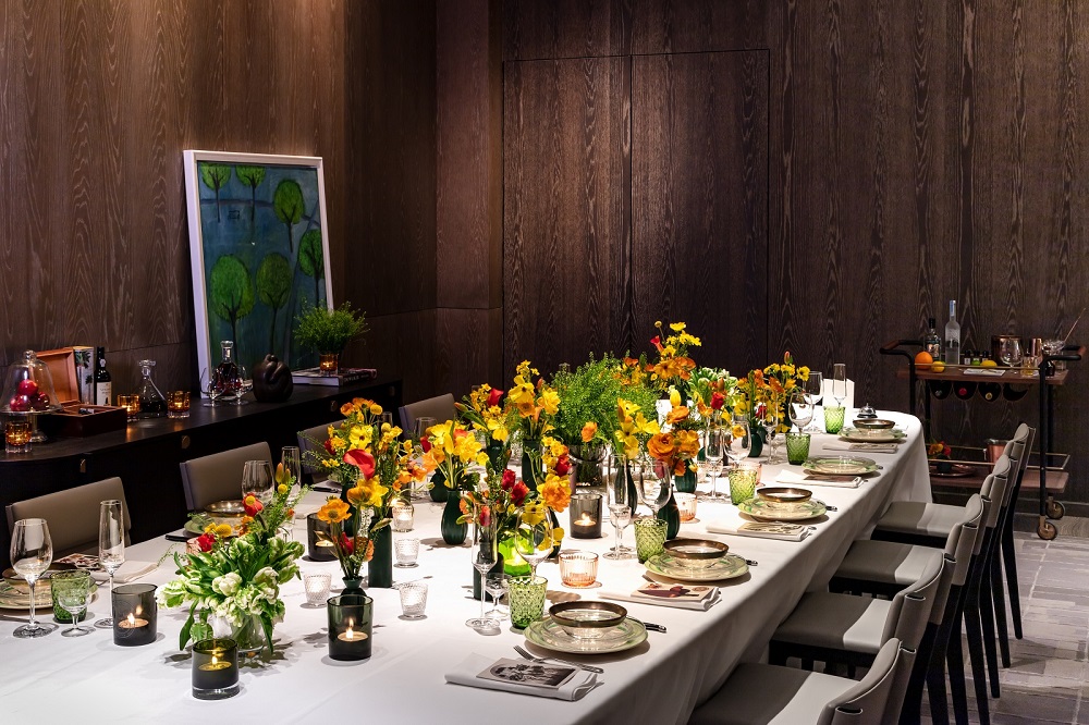 Elegant dining table with floral centerpieces for corporate dinners or private gatherings.