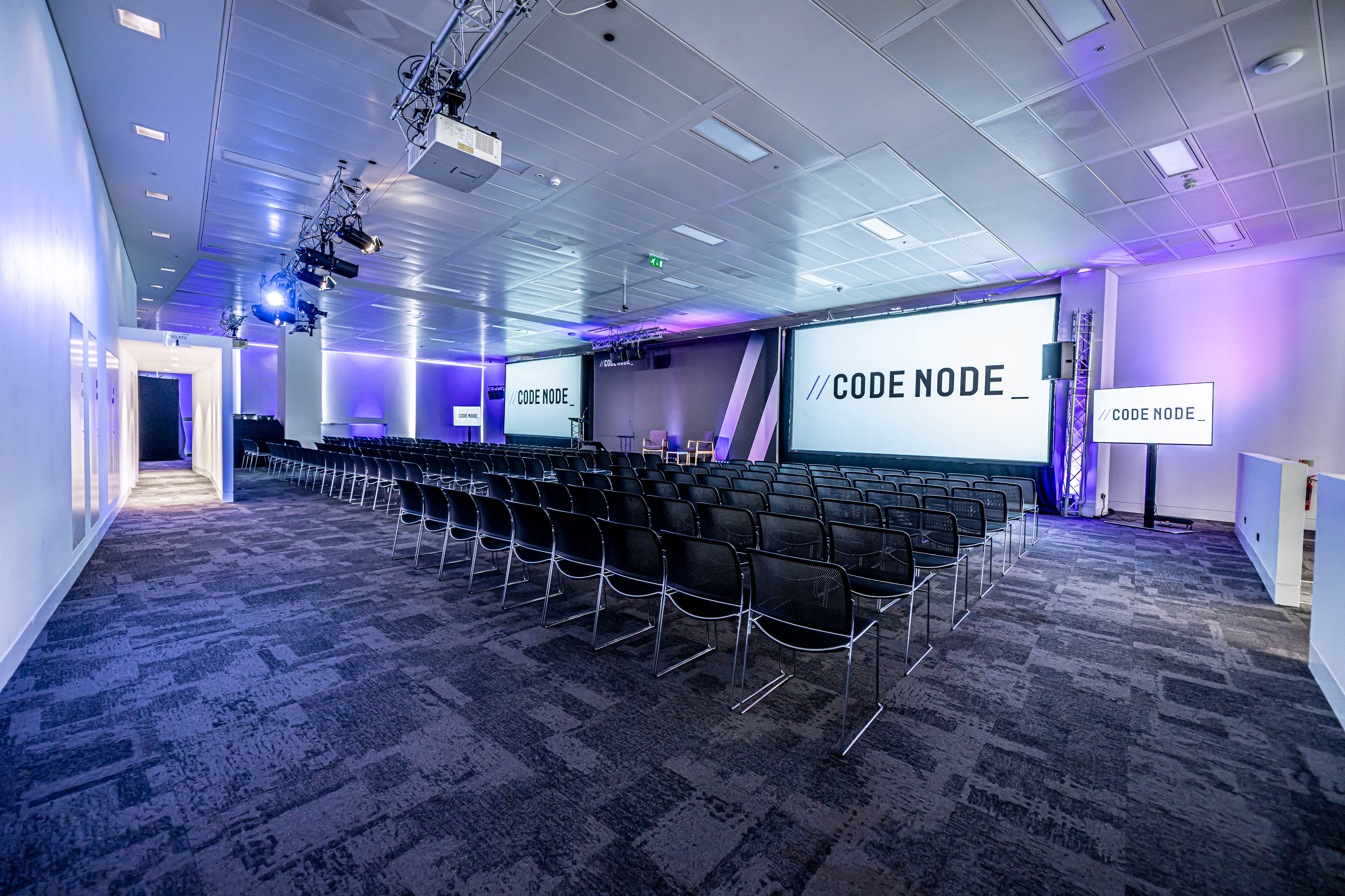 Modern conference venue, CodeNode, projection screens, product launch