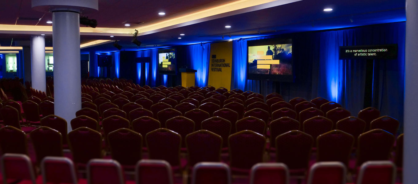 Gorgie Suite event space with red chairs, ideal for conferences and seminars.